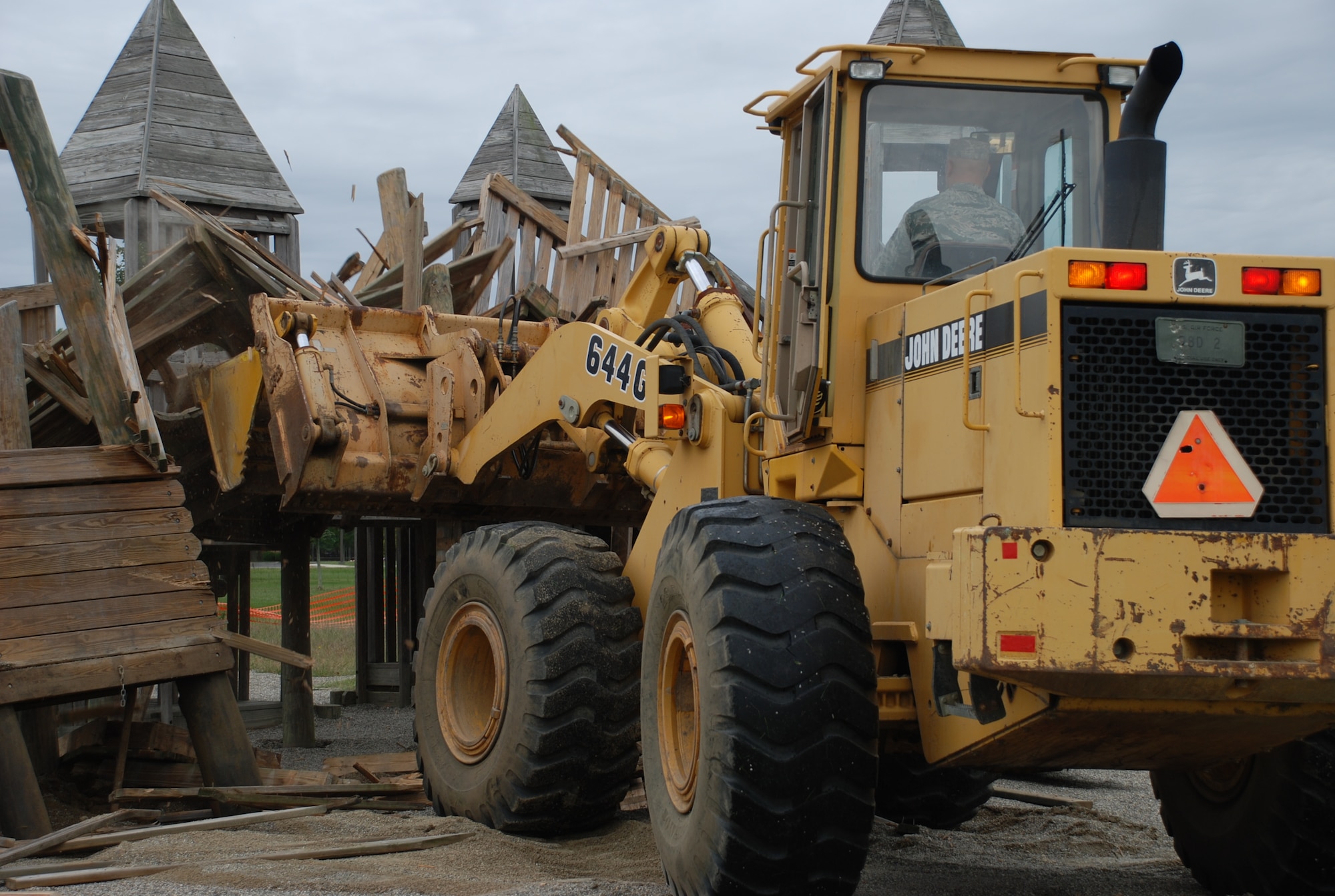 Staff Sgt. Carl Perkins, 305th Civil Engineer Squadron heavy equipment operator, begins the demolition of the Wacky World Playground by the Arnold Gate Sept. 16. Due to the high maintenance and condition of Wacky World, built in 1994, there are plans to replace the playground with a new and improved system that is more durable and up to date. (U.S. Air Force photo/Airman 1st Class Bekah Phy)