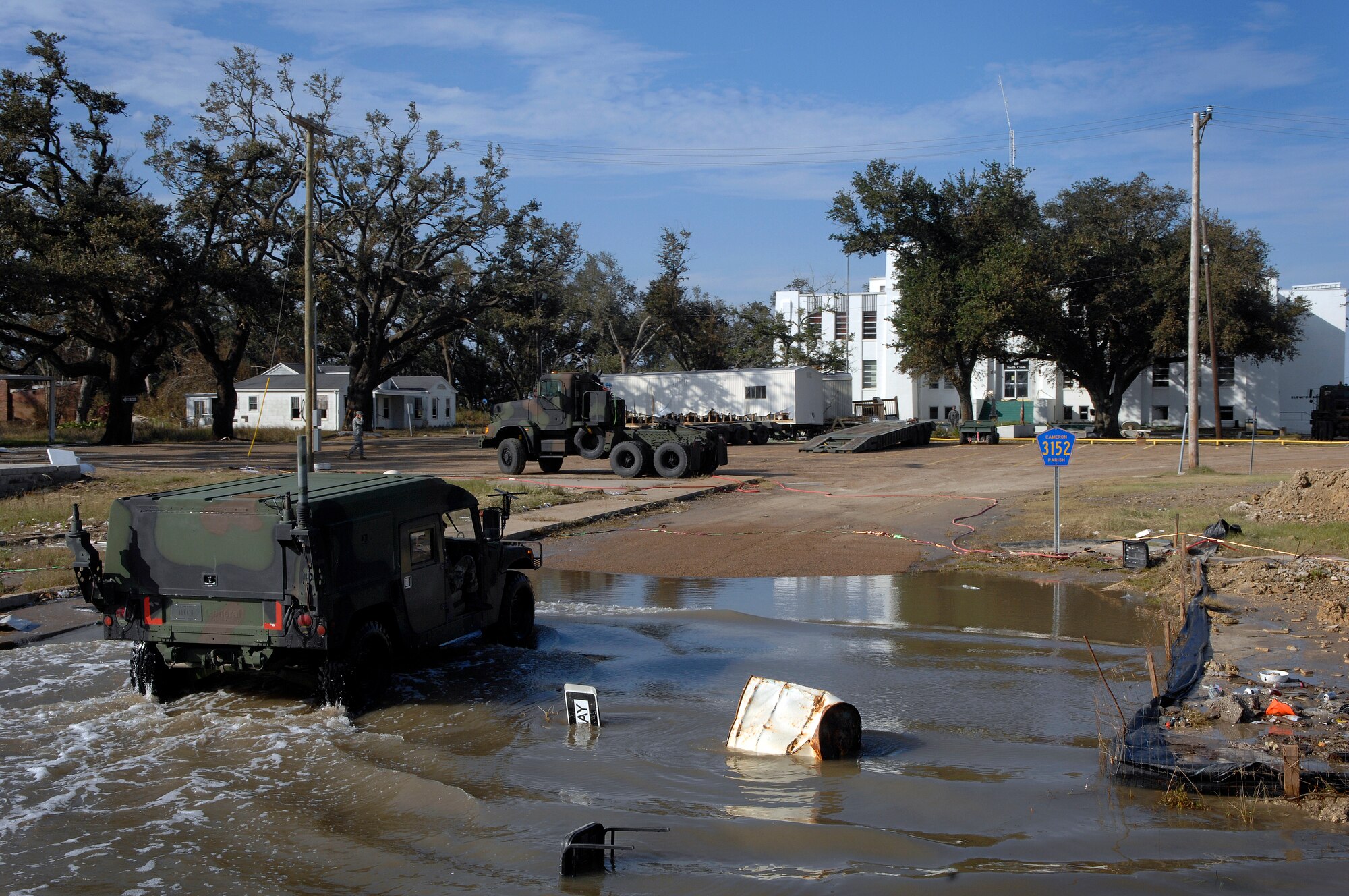 Engineers from the Louisiana Army National Guard's 528th Engineer Battalion pull up to the court house of Cameron, La., where they removed 14 feet of water from the building's basement that was caused by Hurricane Ike. (U.S. Air Force photo/Staff Sgt. Bennie J. Davis III)