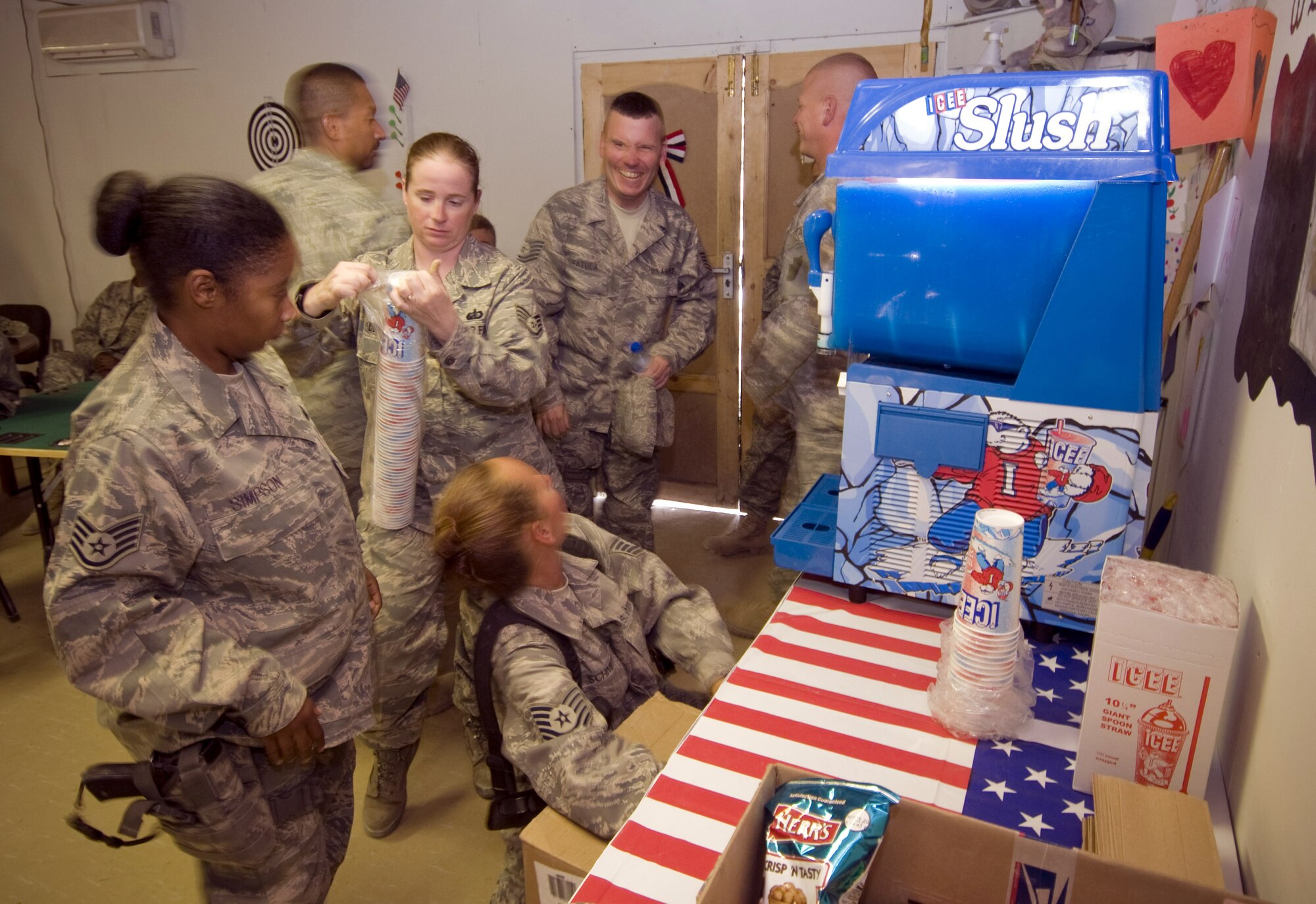 BAGRAM AIR FIELD, Afghanistan - Airmen deployed to forward operating base Mehtar Lam, Afghanistan, get an ICEE machine ready for use in their recreation building on Sept.7. The ICEE machine serves as morale boost to the Airmen who work under the hot Afghan sun. The ICEE machine was donated by the Military Affairs Committee at Mountain Home Air Force Base, Idaho. (U.S. Air Force photo/ Staff Sgt. Samuel Morse)