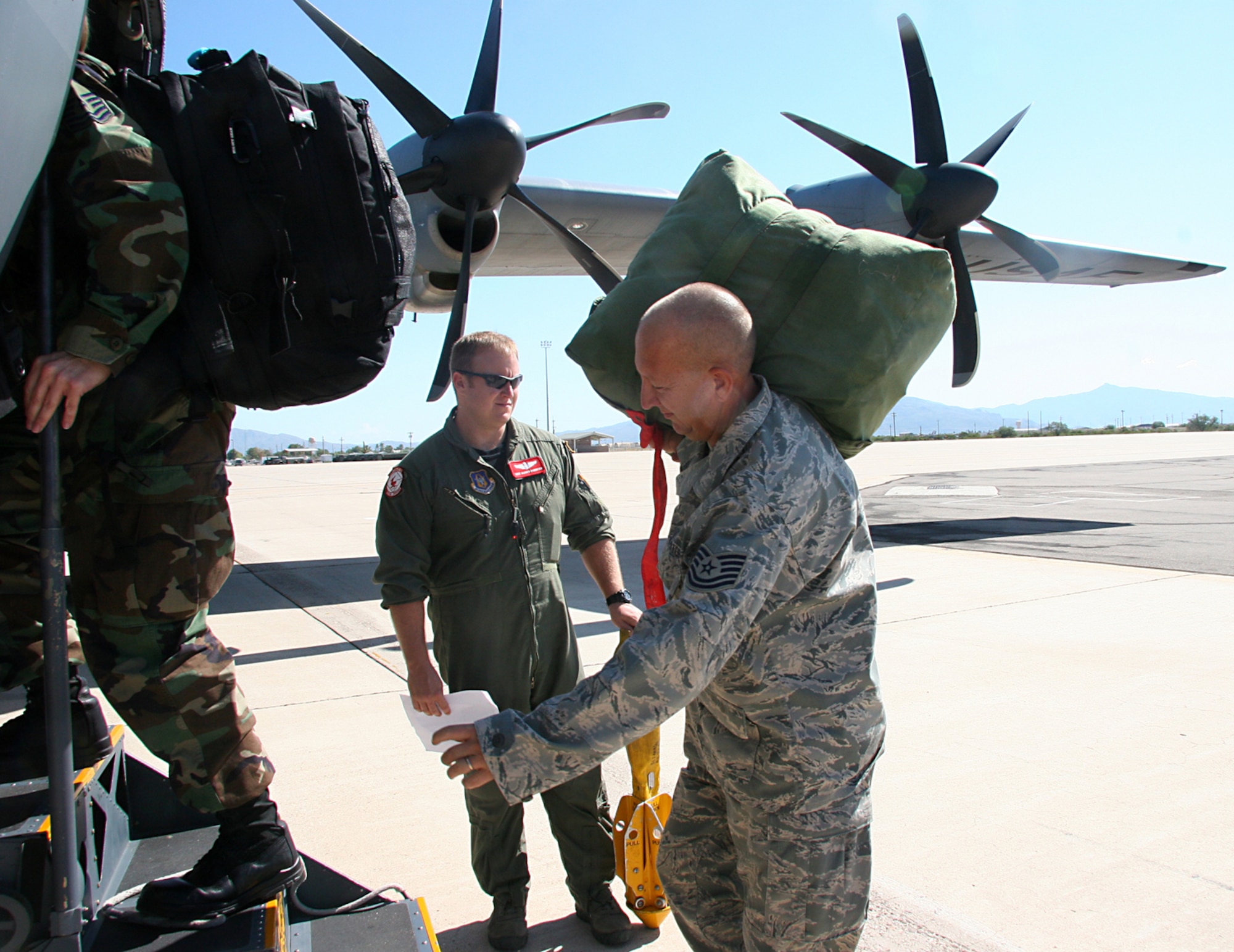 Master Sgt. Darren Bannister, 815th Airlift Squadron loadmaster (AFRC), guides 17 Reservists from Davis-Monthan Air Force Base, Ariz. into a C-130J Hercules Aircraft from Keesler, Air Force Base, Miss., Sept 13, 2008 to transport them to Randolph Air Force Base, Texas to support the search and rescue missions in the aftermath of Hurricane Ike.  These Reservists are aircraft mechanics, intelligence specialist and ground radio specialist from the 943rd Rescue Group.  (U.S. Air Force Photo/Master Sgt. Ruby Zarzyczny)