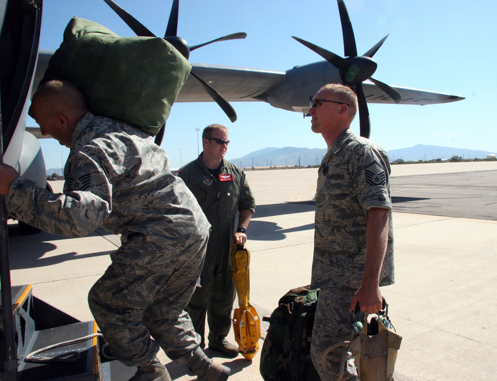 Master Sgt. Darren Bannister, 815th Airlift Squadron loadmaster (AFRC), guides 17 Reservists from Davis-Monthan Air Force Base, Ariz. into a C-130J Hercules Aircraft, Sept 13, 2008 to transport them to Randolph Air Force Base, Texas to support the search and rescue missions in the aftermath of Hurricane Ike.  These Reservists are aircraft mechanics, intelligence specialist and ground radio specialist from the 943rd Rescue Group.  (U.S. Air Force Photo/Master Sgt. Ruby Zarzyczny)