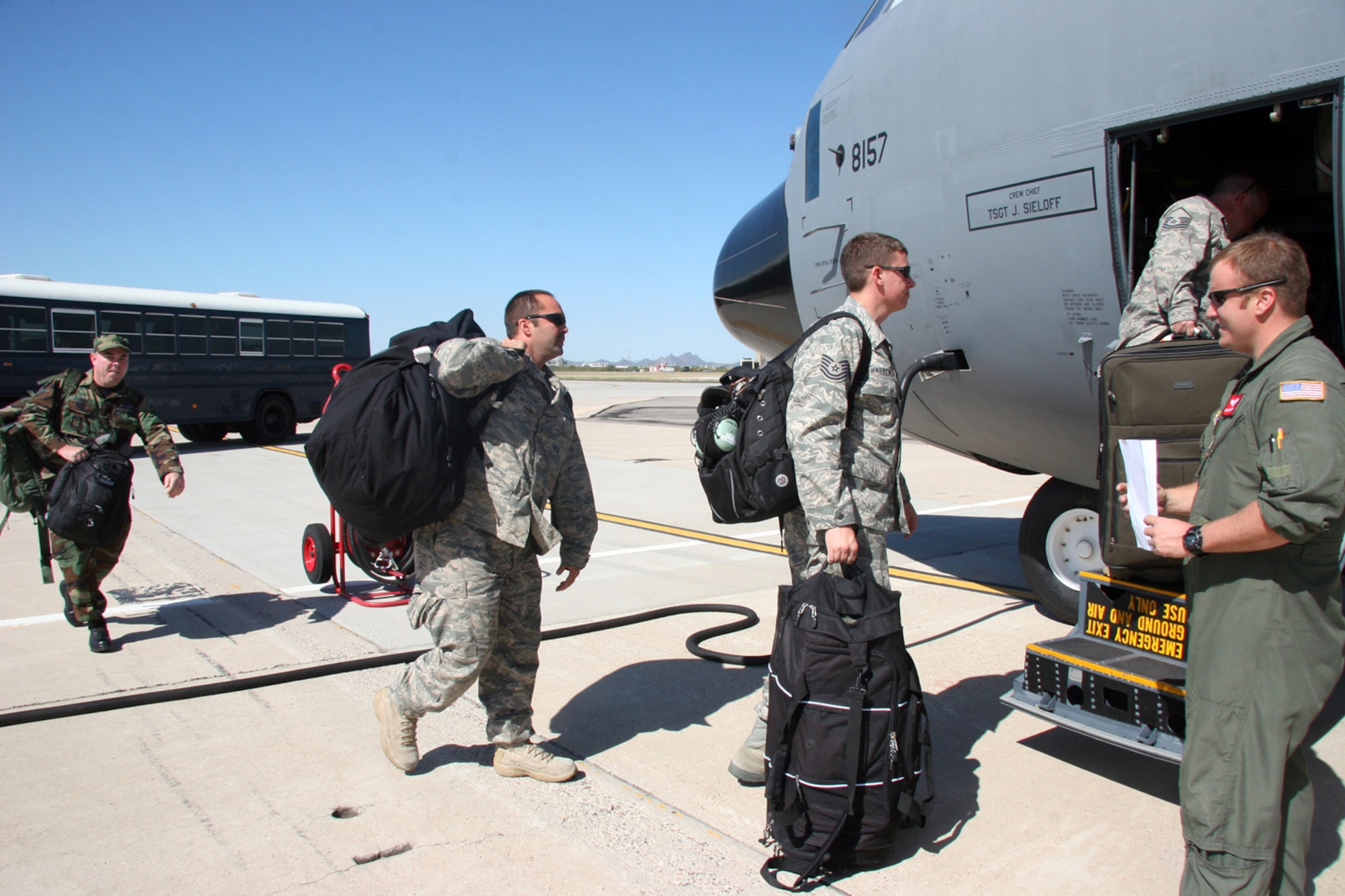 Master Sgt. Darren Bannister, 815th Airlift Squadron loadmaster (AFRC), guides 17 Reservists from Davis-Monthan Air Force Base, Ariz. into a C-130J Hercules Aircraft, Sept 13, 2008 to transport them to Randolph Air Force Base, Texas to support the search and rescue missions in the aftermath of Hurricane Ike.  These Reservists are aircraft mechanics, intelligence specialist and ground radio specialist from the 943rd Rescue Group.  (U.S. Air Force Photo/Master Sgt. Ruby Zarzyczny)