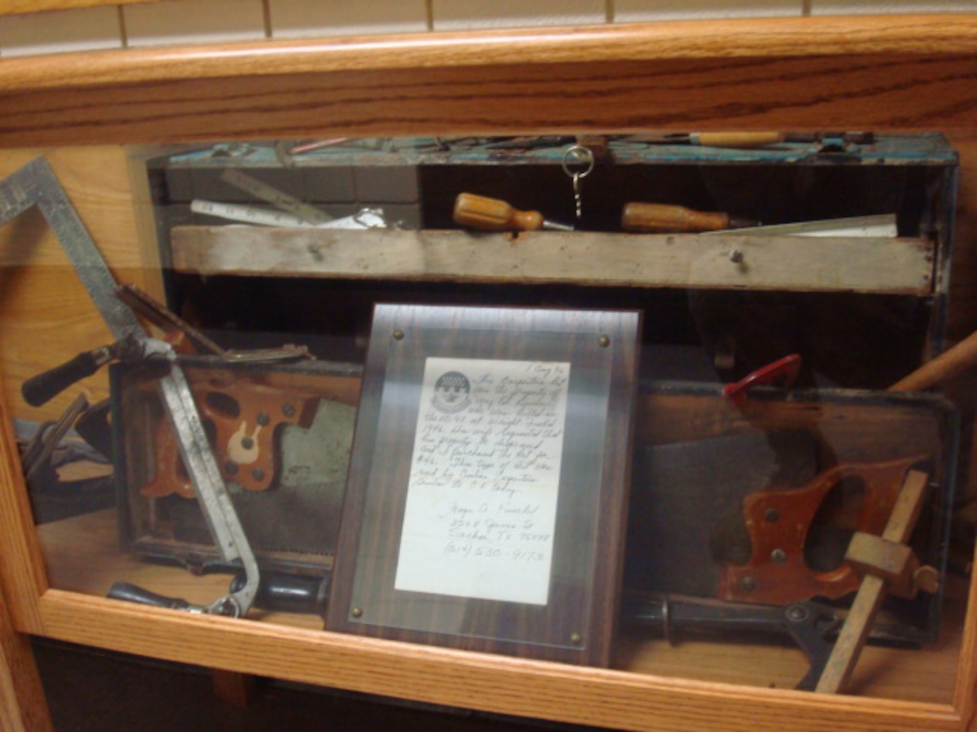 A World War II-era carpenter's tool kit sits in a display case in the Air Force's Structural Apprentice Course dormitory at Naval Construction Training Center, Gulf Port, Miss. The kit was donated to the 366th Training Squadron, Det. 6, by retired Maj. Wayne Kuschel. Major Kuschel purchased the kit in 1947 after the death of its owner, Maj. Edward Dunn, in an XC-97 Stratofreighter crash near Dayton, Ohio. (Courtesy photo)