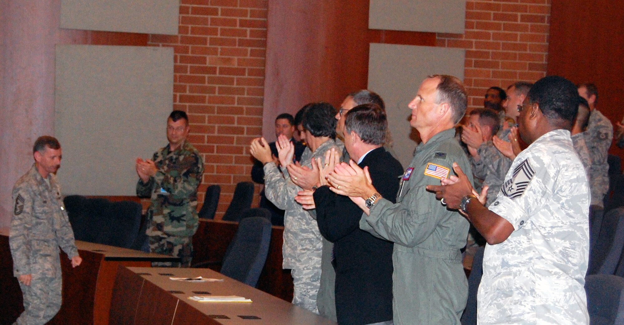 U.S. Air Force Expeditionary Center "Eagles" give a standing ovation to Chief Master Sgt. Jeffry Helm, USAF EC's command chief master sergeant from November 2006 to September 2008, during a commander's call Aug. 25, 2008.  Chief Helm moves on to become the command chief for the Army and Air Force Exchange Service in Dallas, Texas.  (U.S. Air Force Photo/Tech. Sgt. Scott T. Sturkol)