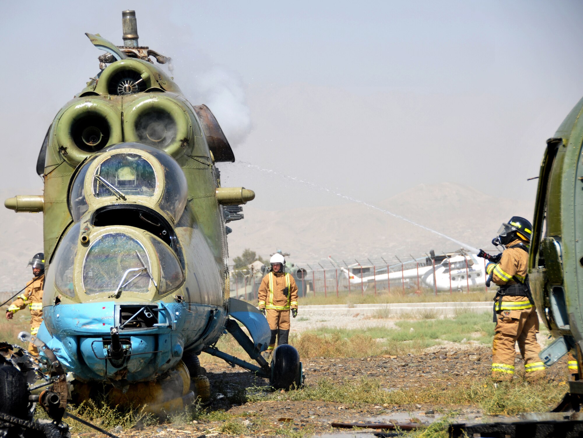 KABUL, Afghanistan -- An Afghan National Army Air Corps fire department member puts out an aircraft fire during an emergency response exercise recently at the Kabul Air Corps Training Center in Afghanistan. Air Corps fire department and quick reaction force members used the live fire exercise to coordinate their response to an aircraft fire.(U.S. Air Force photo/Staff Sgt. Beth Del Vecchio)