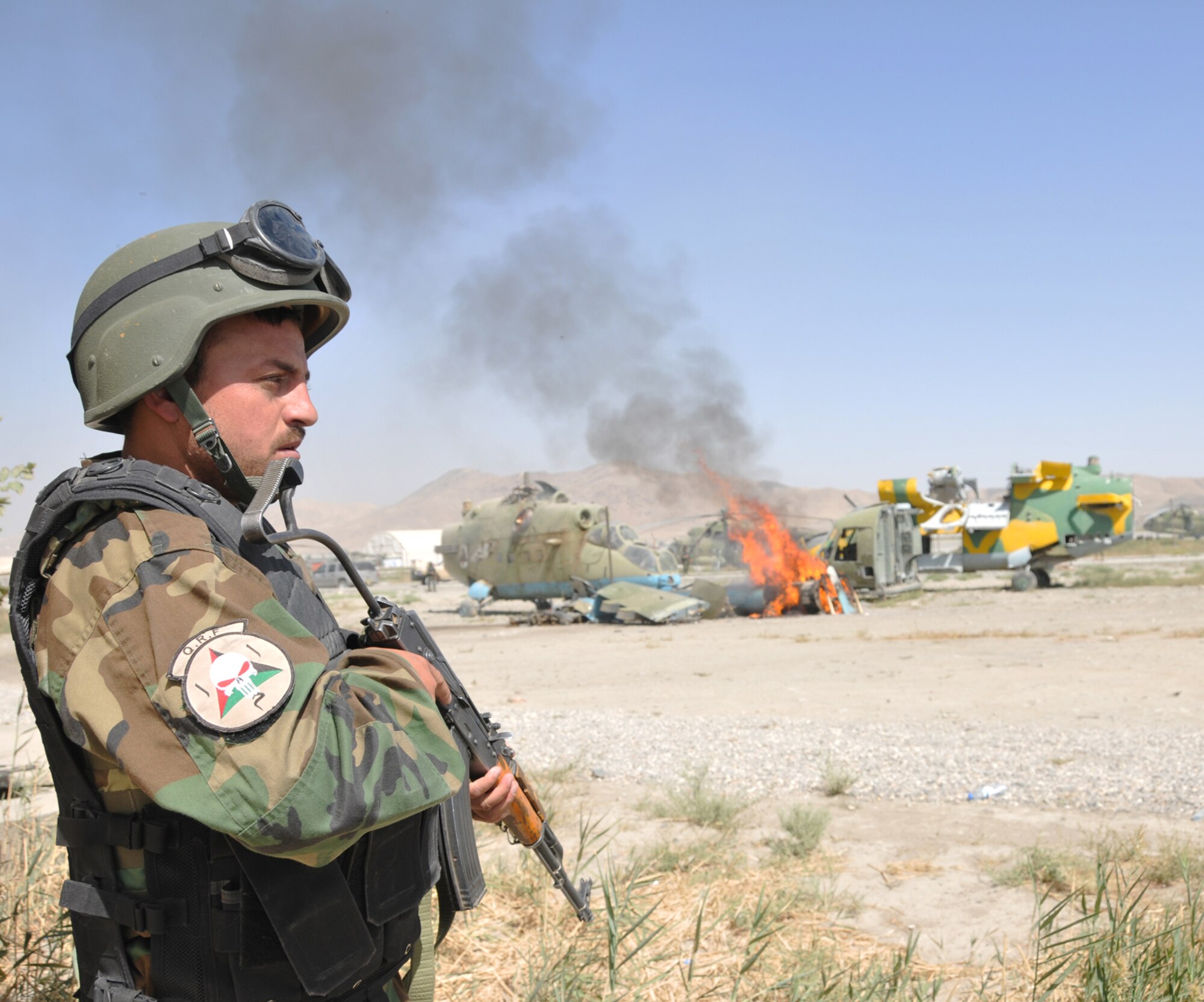 KABUL, Afghanistan -- An Afghan National Army Air Corps quick reaction force member stands guard on a cordon during an emergency response exercise recently at the Kabul Air Corps Training Center in Afghanistan. Air Corps fire department and quick reaction force members used the live fire exercise to coordinate their response to an aircraft fire. (U.S. Air Force photo/Staff Sgt. Beth Del Vecchio)