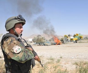 KABUL, Afghanistan -- An Afghan National Army Air Corps quick reaction force member stands guard on a cordon during an emergency response exercise recently at the Kabul Air Corps Training Center in Afghanistan. Air Corps fire department and quick reaction force members used the live fire exercise to coordinate their response to an aircraft fire. (U.S. Air Force photo/Staff Sgt. Beth Del Vecchio)