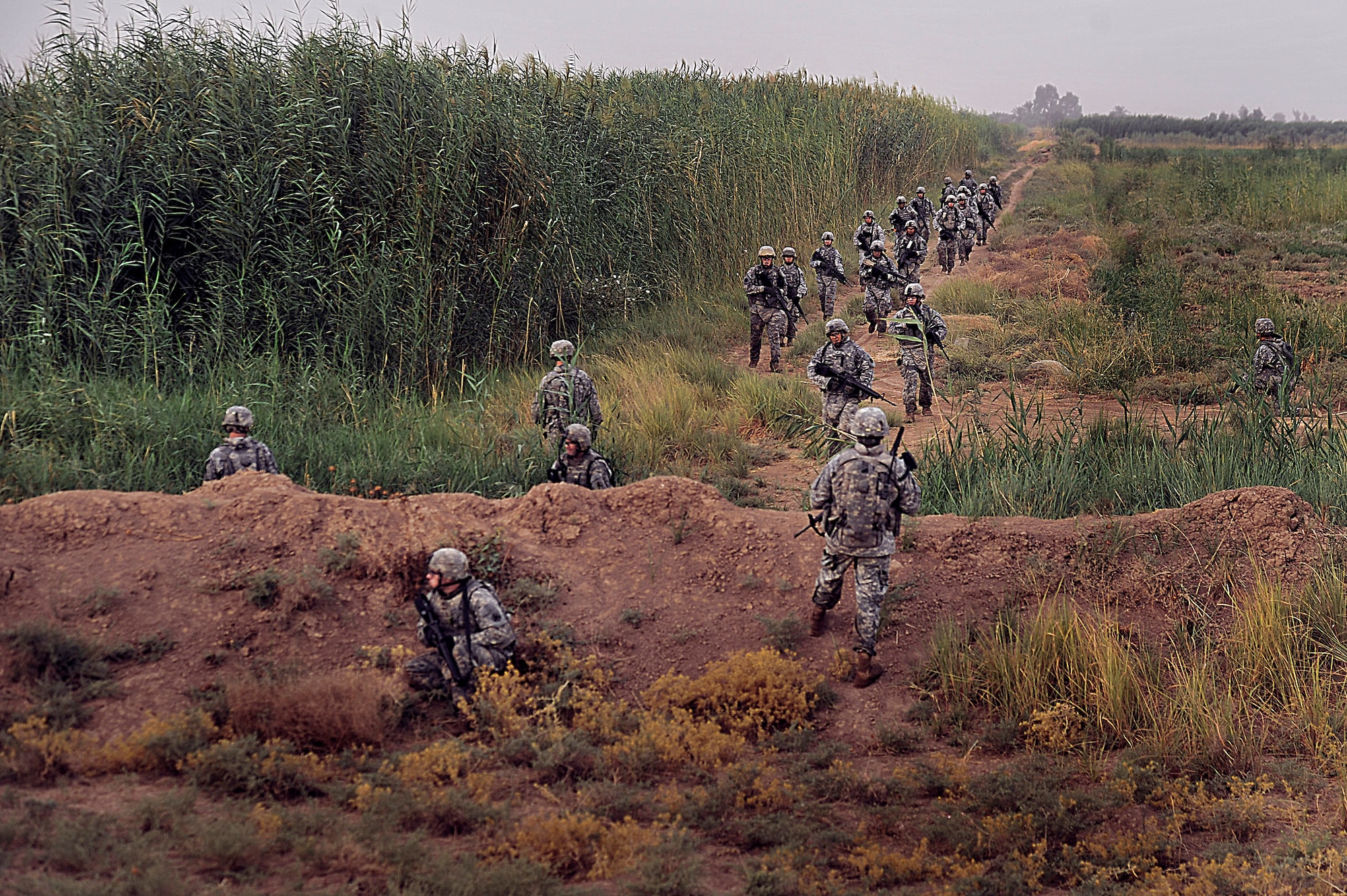 Soldiers and Airmen patrol the perimeter of Joint Base Balad, Iraq during Operation Lewis and Clark Sept. 11. Operation Lewis and Clark was a joint patrol in which Air Force security forces Airmen were introduced to Balad's outer perimeter. Since Americans began operating from Balad in 2003, the Army has been responsible for base security. The 332nd Expeditionary Security Forces Group will soon be the largest security forces unit deployed in combat to defend an air base since Vietnam. (U.S. Air Force photo/Staff Sgt. Aaron Allmon)