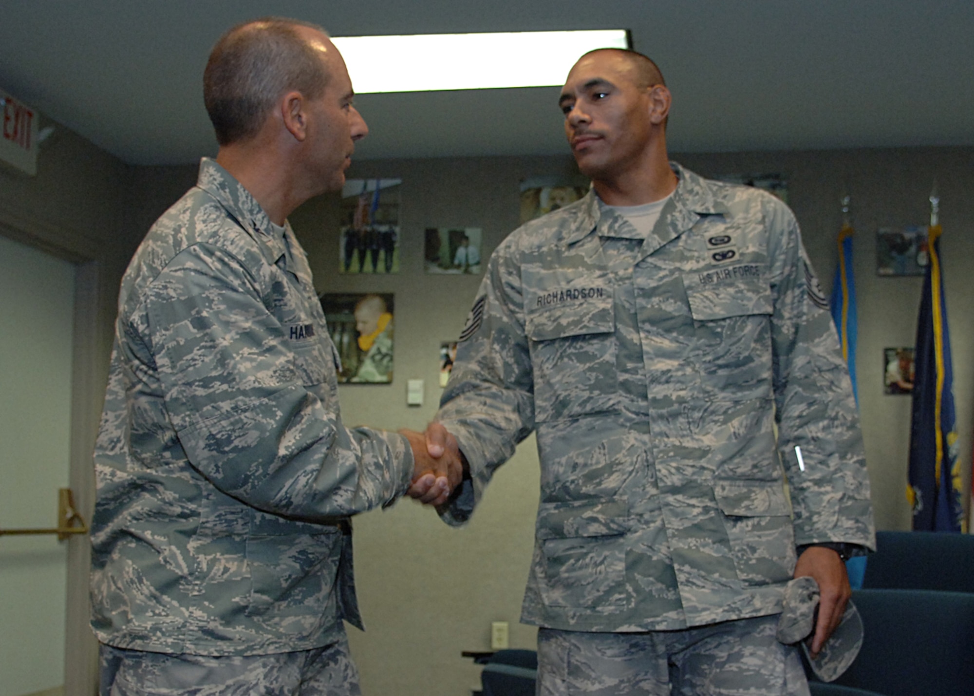 Col. Jeff Harrigian, 49th Fighter Wing commander, shakes the hand of Tech. Sgt. Sascha Richardson, 49th Operation Support Squadron, after he arrives home, September 3, at Holloman Air Force Base, N.M. (U.S. Air Force photo by Airman 1st Class John D. Strong II)