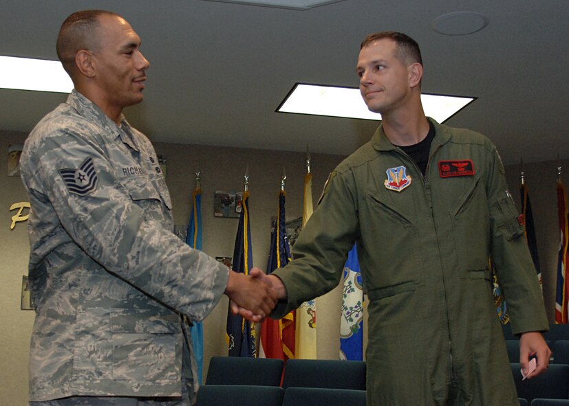Lt .Col.  Alexus Grynkewich, 49th Operation Support Squadron commander, congratulates Tech. Sgt.  Sascha Richardson, 49th Operations Support Squadron,  for returning home safely, September 3, at Holloman Air Force Base, N.M.  (U.S. Air Force photo by Airman 1st Class John D. Strong II)