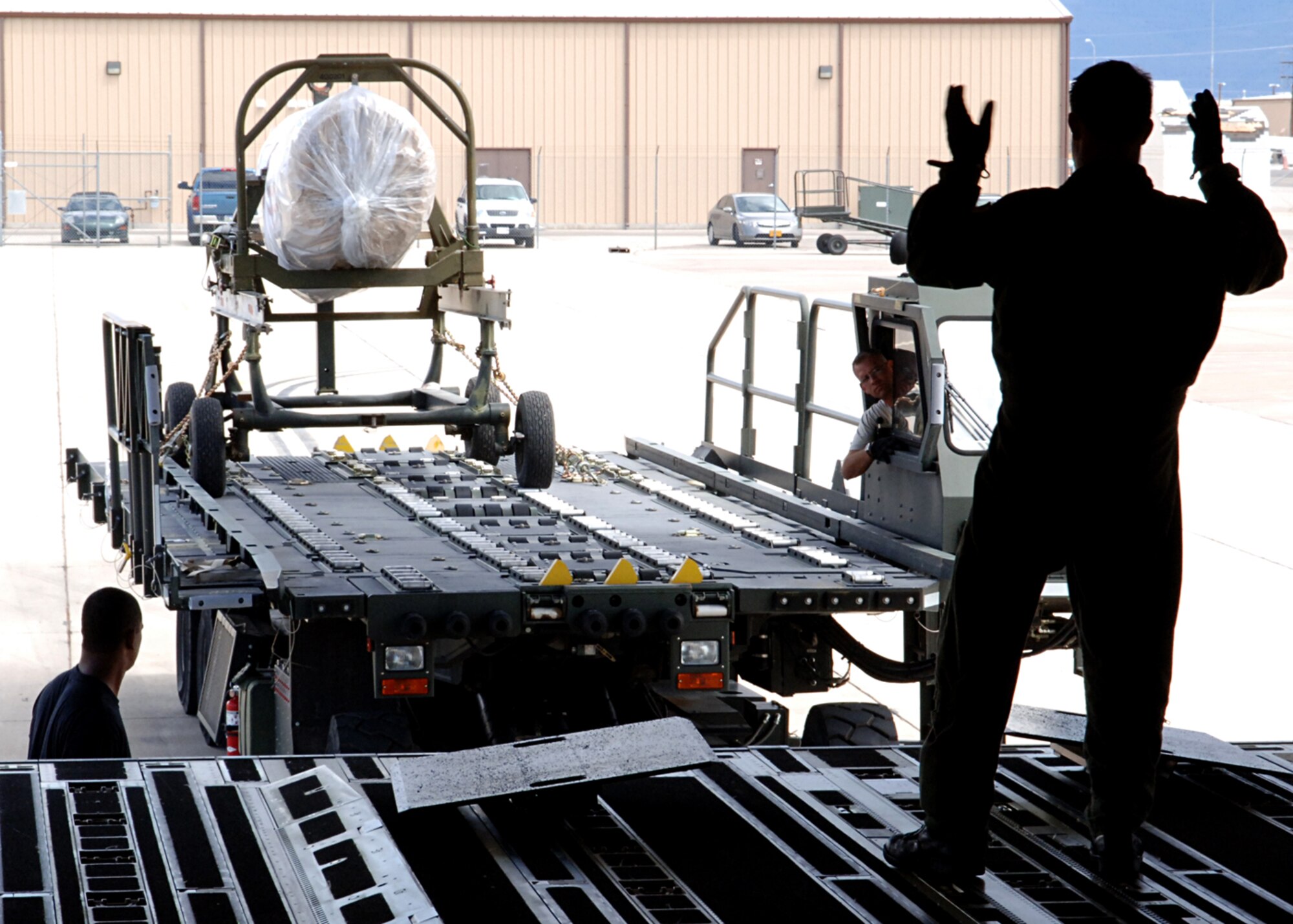 Tech Sgt. Geoffrey Parish, 729th Airlift Squadron, navigates the last pieces of the F-117A on to a C-17, at Holloman Air Force Base, N.M.  The C-17 used to transport the remaining pieces of the F-117A was flown from March Air Force Base, C.A.  (U.S. Air Force photo by Airman 1st Class John D. Strong II)