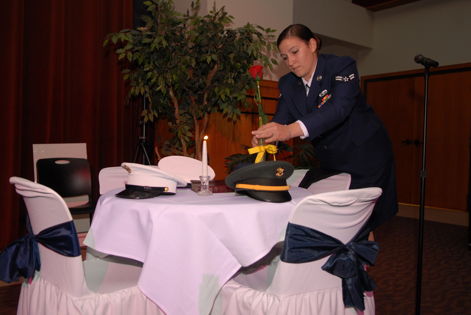 Airman 1st Class Kaitlyn Salvatore, 17th Communications Squadron, places a single rose on the POW/MIA table to remind 2008 Air Force Ball attendees of the families and loved ones of our comrades in arms who keep faith awaiting their return. (U.S. Air Force photo by Senior Airman Kasabyan Musal)