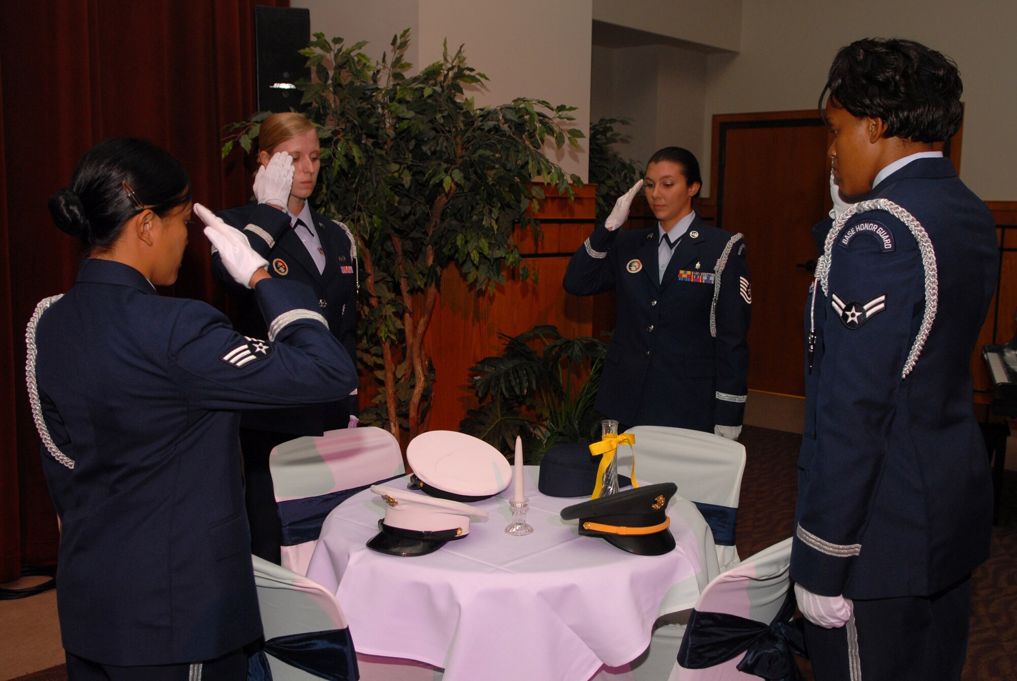 Members of the Goodfellow Air Force Base Honor Guard salute the POW/MIA table at the 2008 Air Force Ball Sept. 12 at the C.J. Davidson Conference Center at Angelo State University. (U.S. Air Force photo by Senior Airman Kasabyan Musal)