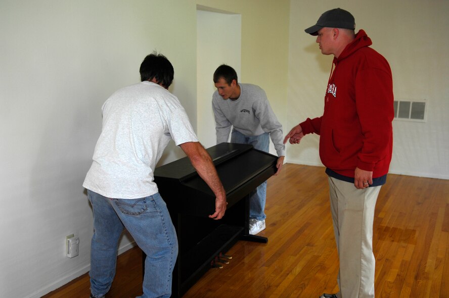 MINOT AIR FORCE BASE, N.D. --1st Lt. Christopher Whited (right), 5th Medical Group physician’s assistant, directs the placement of his piano in his new home here, Sept. 9. The lieutenant and his family were the first to experience the Department of Defense's new Defense Personal Property System by recently permanently changing station from the Air Force Academy at Colorado Springs, Colo., to Minot AFB. DPS is an automated management system for movement of household goods belonging to service members and government civilians (U.S. Air Force photo by Senior Airman Joe Rivera)