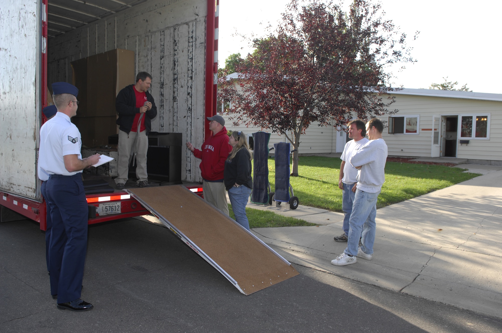 MINOT AIR FORCE BASE, N.D. --1st Lt. Christopher Whited, 5th Medical Group physician’s assistant, and wife Deanna (center) receive their household goods at their new home here, Sept. 9. The lieutenant and his family were the first to experience the Department of Defense's new Defense Personal Property System by recently permanently changing station from the Air Force Academy at Colorado Springs, Colo., to Minot AFB. DPS is an automated management system for movement of household goods belonging to service members and government civilians (U.S. Air Force photo by Senior Airman Joe Rivera)