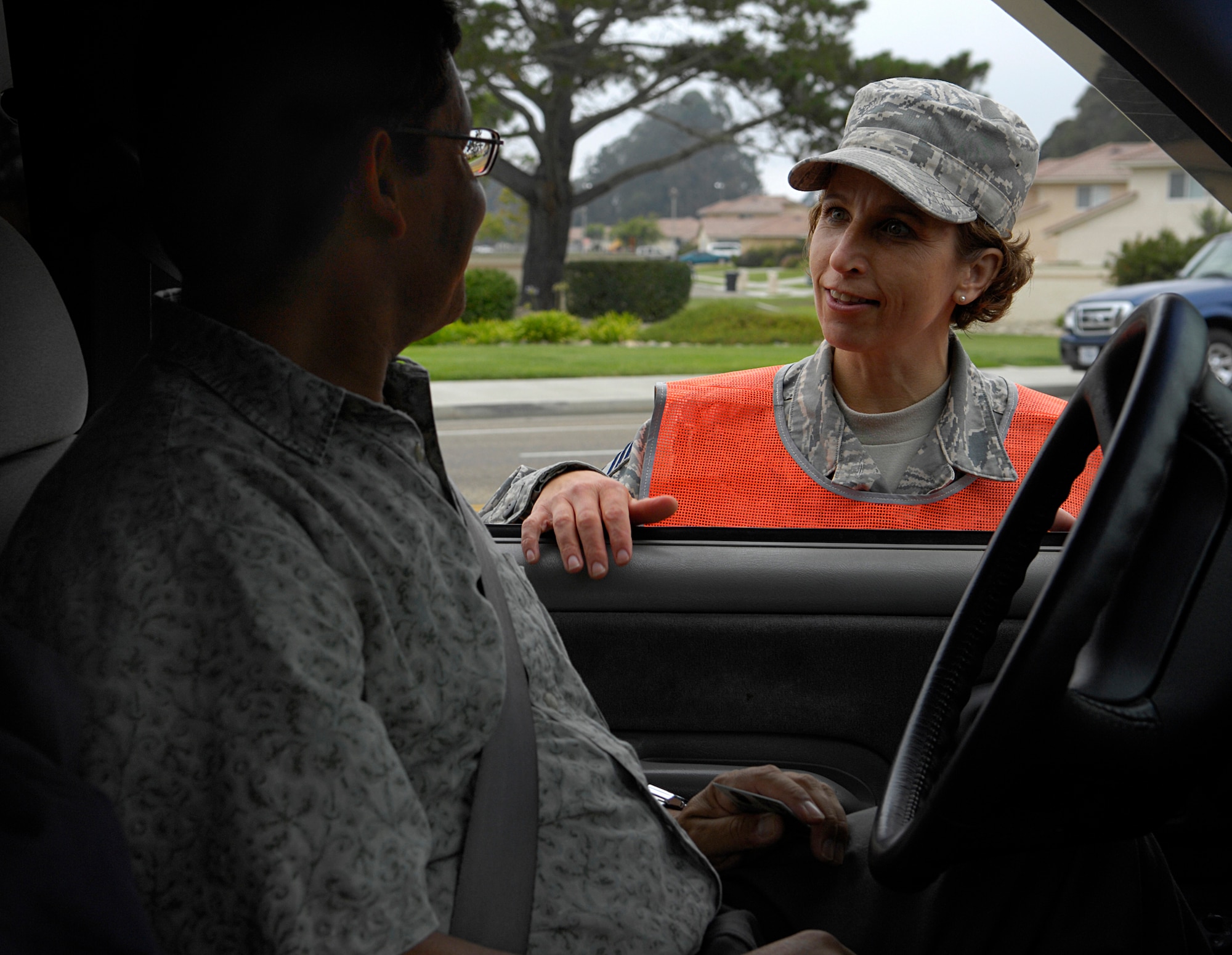 VANDENBERG AIR FORCE BASE, Calif- Command Chief Master Sgt. Cari Kent of 30th Space Wing stops a random car to ensure each individual is wearing a seat belt during a safety belt inspection at the Santa Maria Gate here Sept. 11. This particular event highlighted the continuing vigilance of wing safety and security forces personnel in enforcing these national and state laws. (U.S. Air Force Photo/ by Airman 1st Class Andrew Lee)
