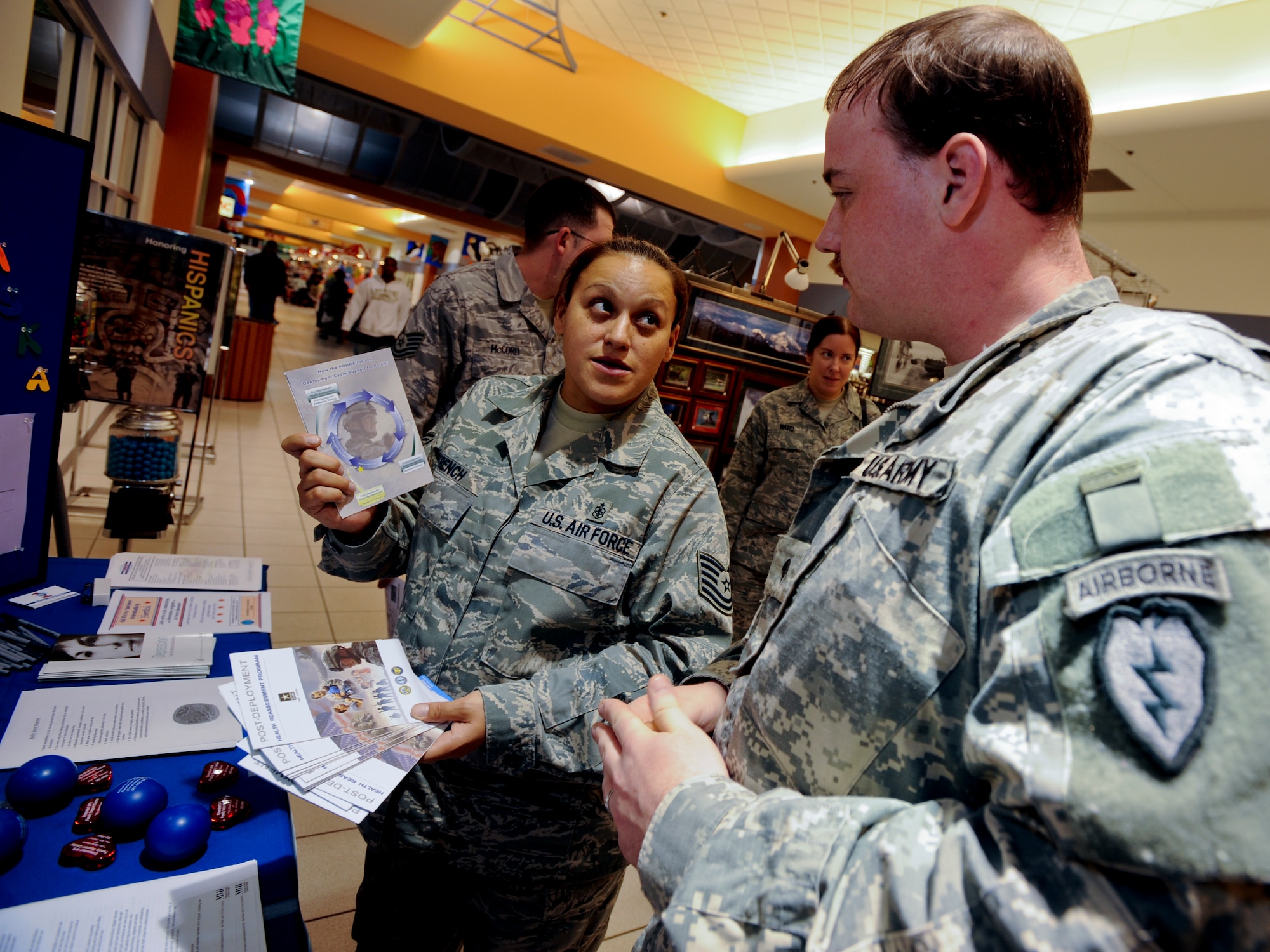 ELMENDORF AIR FORCE BASE, Alaska -- Tech. Sgt. Angelique French, 3rd Medical Operation Squadron, talks to Army Spc. Patrick McNamee, 425th Brigade Special Troop Battalion, about information and programs to help prevent and suicide awareness. The information can be used by the servicemembers or given to the spouses. (U.S. Air Force photo/Staff Sgt. Joshua Garcia)