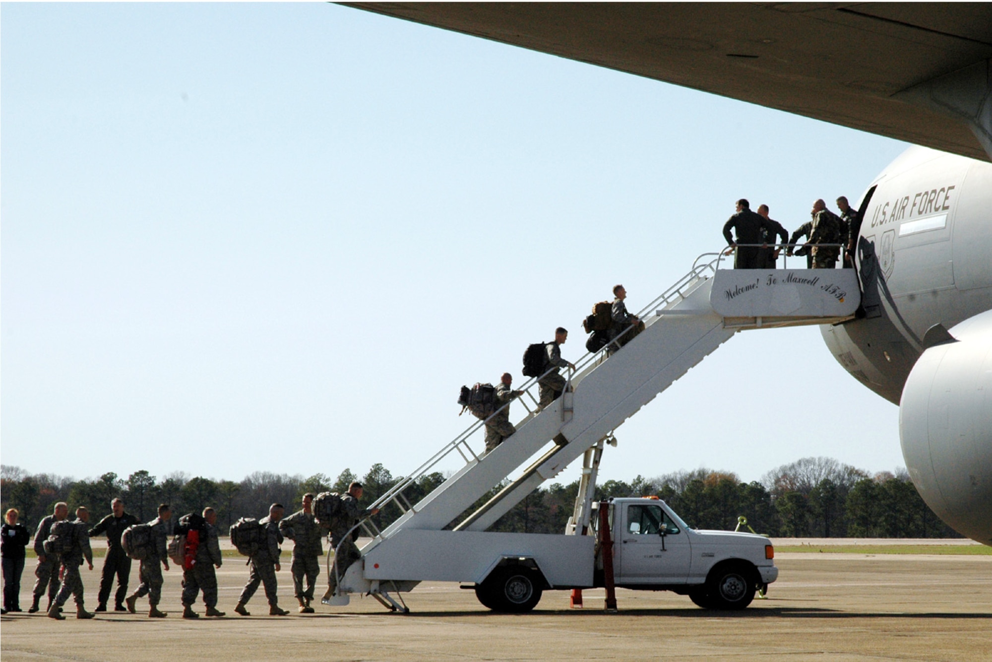 Air Force Reservists from the 908th Airlift Wing board a KC-10 aircraft from McGuire AFB, N.J., bound for Southwest Asia to provide support for Operation Iraqi Freedom. The Montgomery, Ala.-based 908th AW was the first C-130 unit in Air Force Reserve Command to deploy under a rotation system filled by volunteers. Reservists who deploy will find most of their benefits are the same whether they volunteer or they are mobilized. (Jeff Melvin)