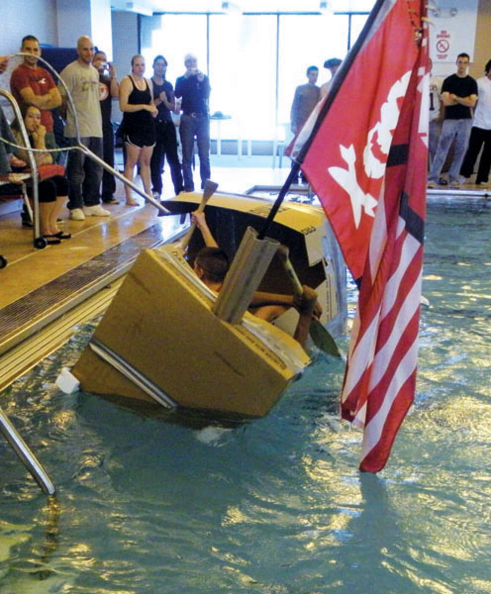 Scott McNutt and his son pilot their team’s boat around the aquatic center’s pool Saturday.
