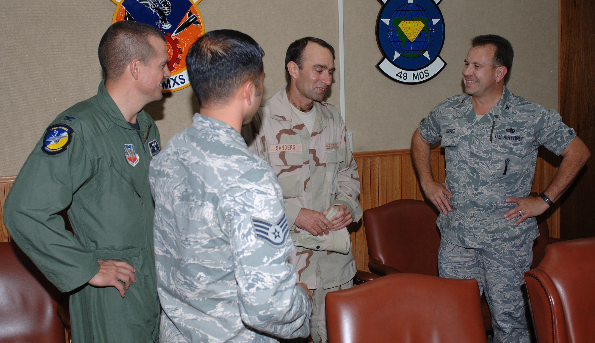 Master Sgt. Jeffery Sanders, 49th Maintenance Operations Squadron, is greeted by Col. Michael McGee, 49th Fighter Wing vice commander and Col. George Torres, 49th Maintenance Group commander Sept. 12 at Holloman Air Force Base, N.M., after returning home from a four month deployment to Al Udeid Air Base, Qutar.  (U.S. Air Force photo/Airman 1st Class Michael Means)
