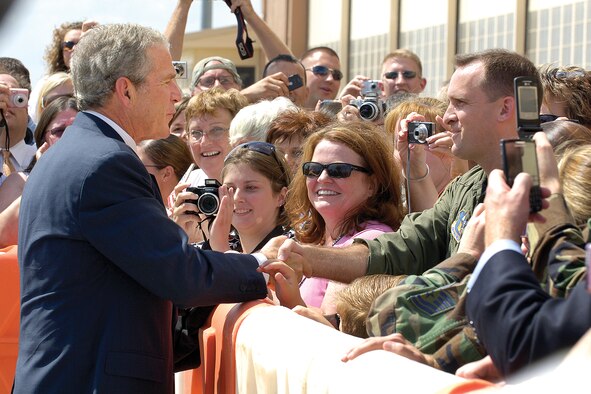 President Bush shakes hands with Maj. Paul Ihrig of the 465th Refueling Squadron during a visit to Tinker and Oklahoma City Sept. 12. He landed at Tinker in the morning and while he was here, honored Karen Stark, an Edmond woman who has been sending “hugs,” cooling ties worn around the neck. She and her volunteers have sent more than 5,000 hugs to troops stationed overseas.(Air Force photo/Margo Wright)