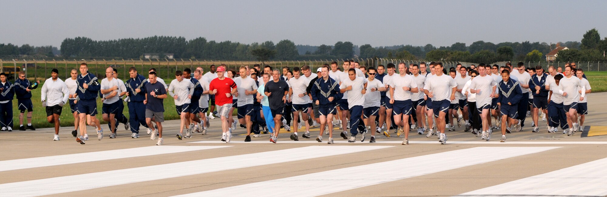 Airmen take off from the start line and down the runway to begin the POW/MIA Remembrance 5k Run at RAF Mildenhall, England, Sept. 15, 2008. The run kicked off POW/MIA Remembrance Week which runs Sept. 15 through 19. (U.S. Air Force photo by Staff Sergeant Jerry Fleshman)