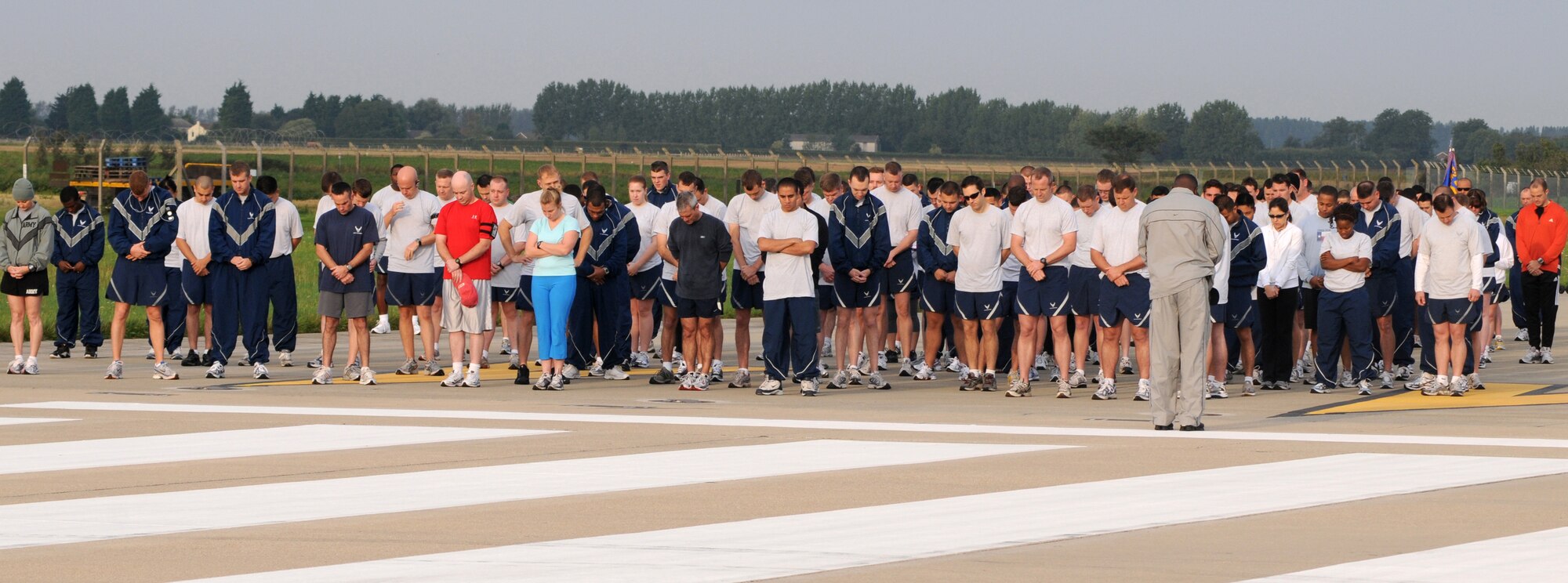 Airmen bow their heads for a moment of silence prior to the POW/MIA 5k run located on RAF Mildenhall, Sept. 15, 2008. The run was held to honor those individuals who became prisoners of war and also to pay respect to all those missing in action who never made it home. (U.S. Air Force photo by Staff Sergeant Jerry Fleshman)