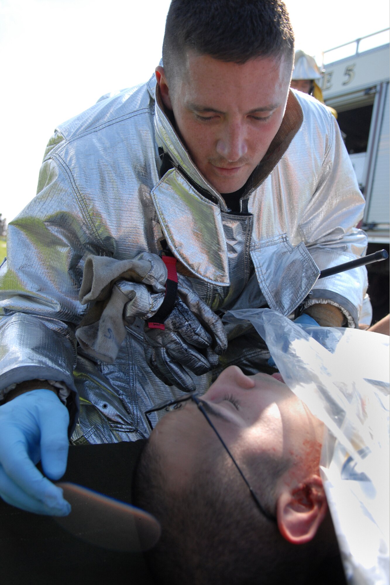 MISAWA AIR BASE, Japan -- Senior Airman Nathan Shaw, 35th Civil Engineer Squadron, aids Senior Airman Esparza Gilbert, 35th Communications Squadron, during an emergency management exercise Sept. 16, 2008. Airman Shaw was part of the rescue team that responded to a simulated propane explosion. (U.S. Air Force photo by Airman 1st Class Jamal D. Sutter)