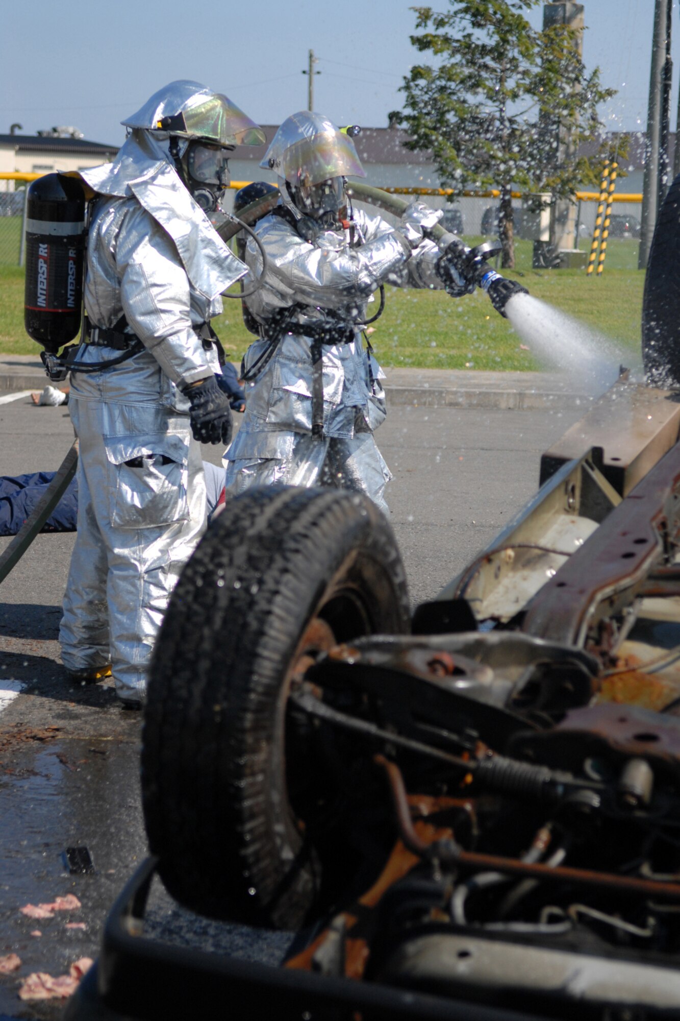 MISAWA AIR BASE, Japan -- 35th Civil Engineer Squadron firefighters combat a simulated fire during an emergency management exercise Sept. 16, 2008. The firefighters were part of a rescue team that responded to a simulated propane explosion. (U.S. Air Force photo by Airman 1st Class Jamal D. Sutter)