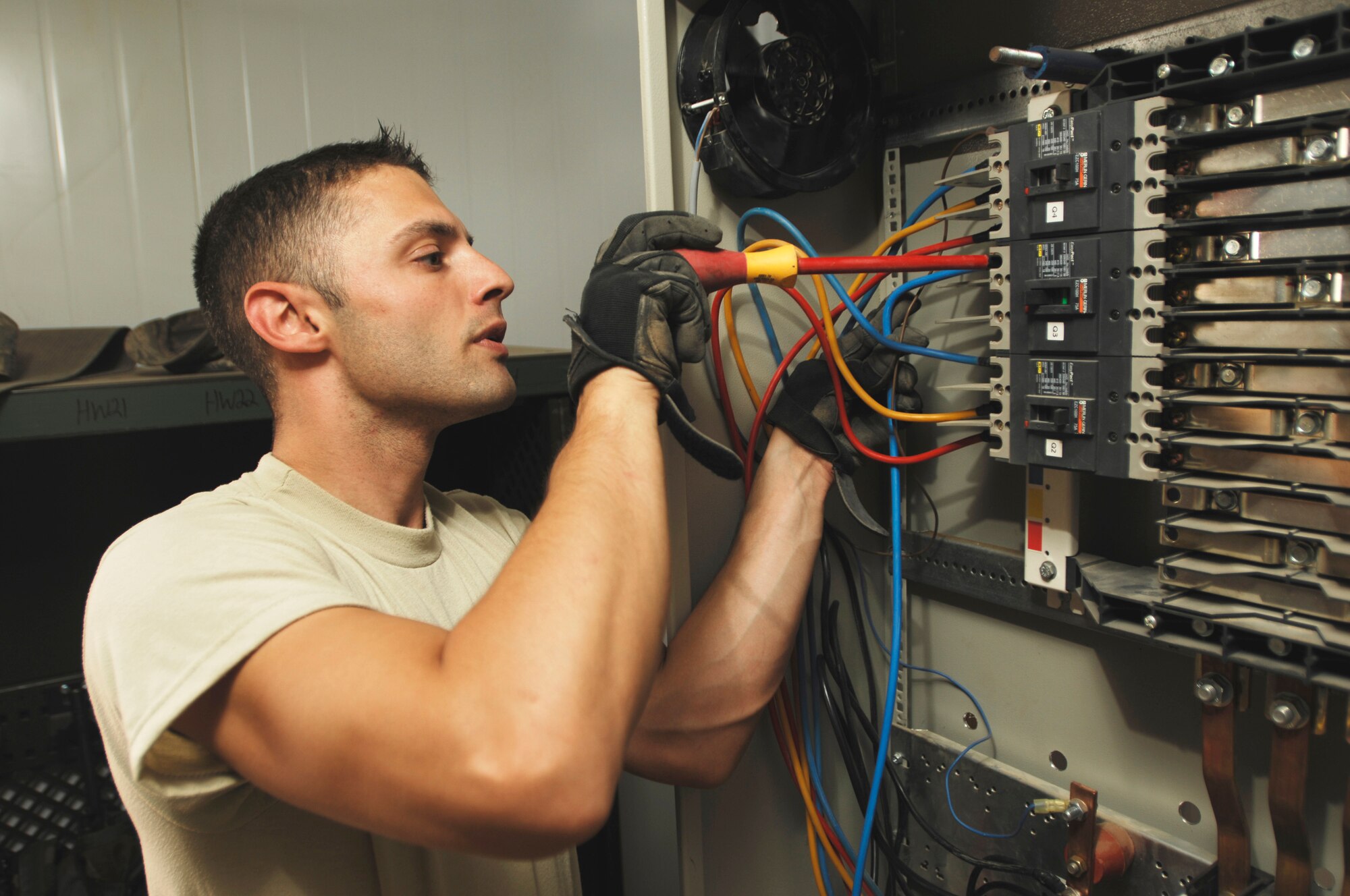 JOINT BASE BALAD, Iraq - Staff Sgt. Rocky Edwards connects electrical wires to a circuit breaker here Sept. 9. Edwards, an electrical systems craftsman assigned to the 332nd Expeditionary Civil Engineer Squadron, installed power to a new trailer that will be used by the 332nd Expeditionary Security Forces Group as a workspace for the Air Force's assumption of Joint Base Balad's security. Edwards is deployed from Cannon Air Force Base, N.M. (U.S. Air Force photo/Airman 1st Class Jason Epley)