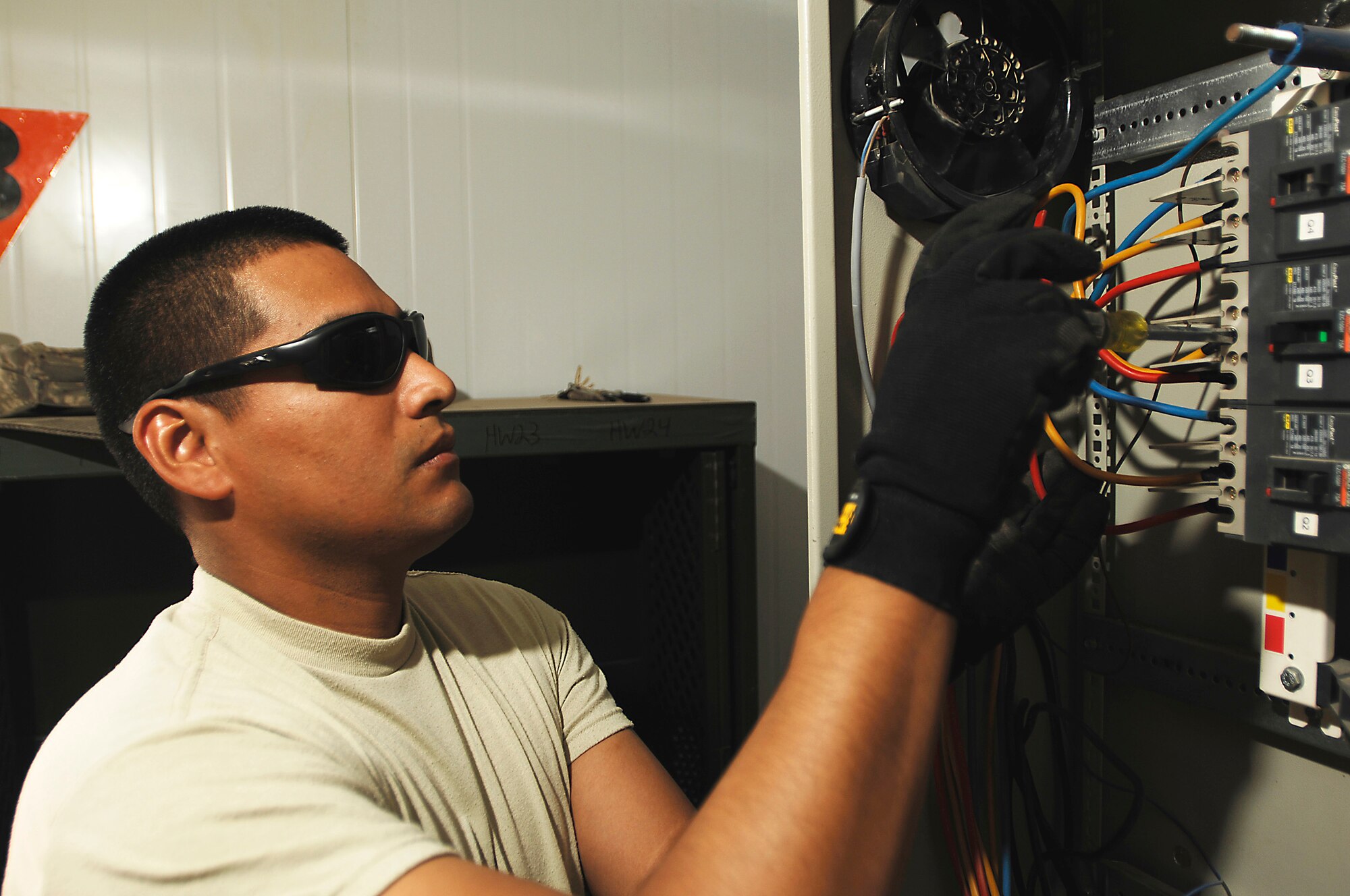 JOINT BASE BALAD, Iraq - Tech. Sgt. Eduardo Zepeda disconnects wires from a circuit breaker here Sept. 9. Zepeda, a 332nd Expeditionary Civil Engineer Squadron electrical systems craftsman, installed power to a trailer that will be used by the 332nd Expeditionary Security Forces Group as a workspace for the Air Force's assumption of Joint Base Balad's security. He is deployed from Anderson Air Force Base, Guam. and his hometown is Ft. Bragg, N.C. (U.S. Air Force photo/Airman 1st Class Jason Epley)