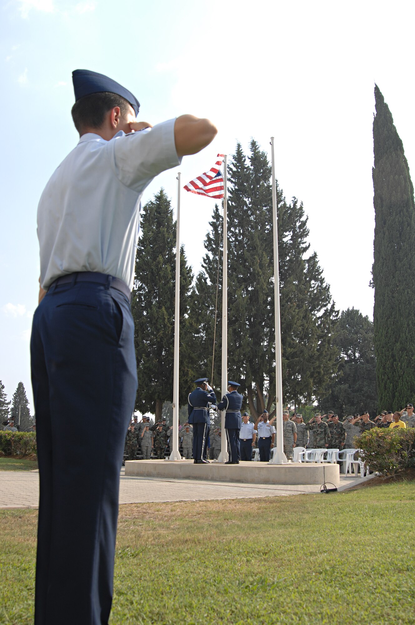 Airman 1st Class Phillip Turner, 39th Civil Engineer Squadron, salutes the flag while base honor guard members raise the flag to full staff before lowering it during a retreat ceremony, Sept. 11. The flag was held at half staff throughout the day in memory of the victims of 9/11. (U.S. Air Force photo by Senior Airman Benjamin Wilson)