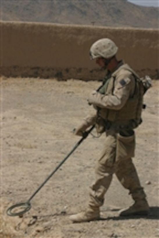 U.S. Marine Corps Lance Cpl. Zachary R. Picking, of 3rd Combat Engineer Battalion, Foxtrot Company, 2nd Battalion, 7th Marine Regiment, sweeps the streets for improvised explosive devices during a patrol with British Royal Marines in Now Zad, Afghanistan, on Sept. 12, 2008.  The U.S. Marine unit, which is a reinforced light infantry battalion, is clearing the city of improvised explosive devices.  