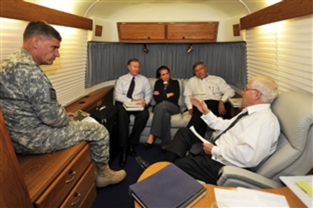 U.S. Defense Secretary Robert M. Gates talks with members of his staff onboard a U.S. Air Force C-17 Globemaster III aircraft enroute to Kabul, Afghanistan, Sept. 16, 2008. Gates is scheduled to meet with Afghan leaders. 