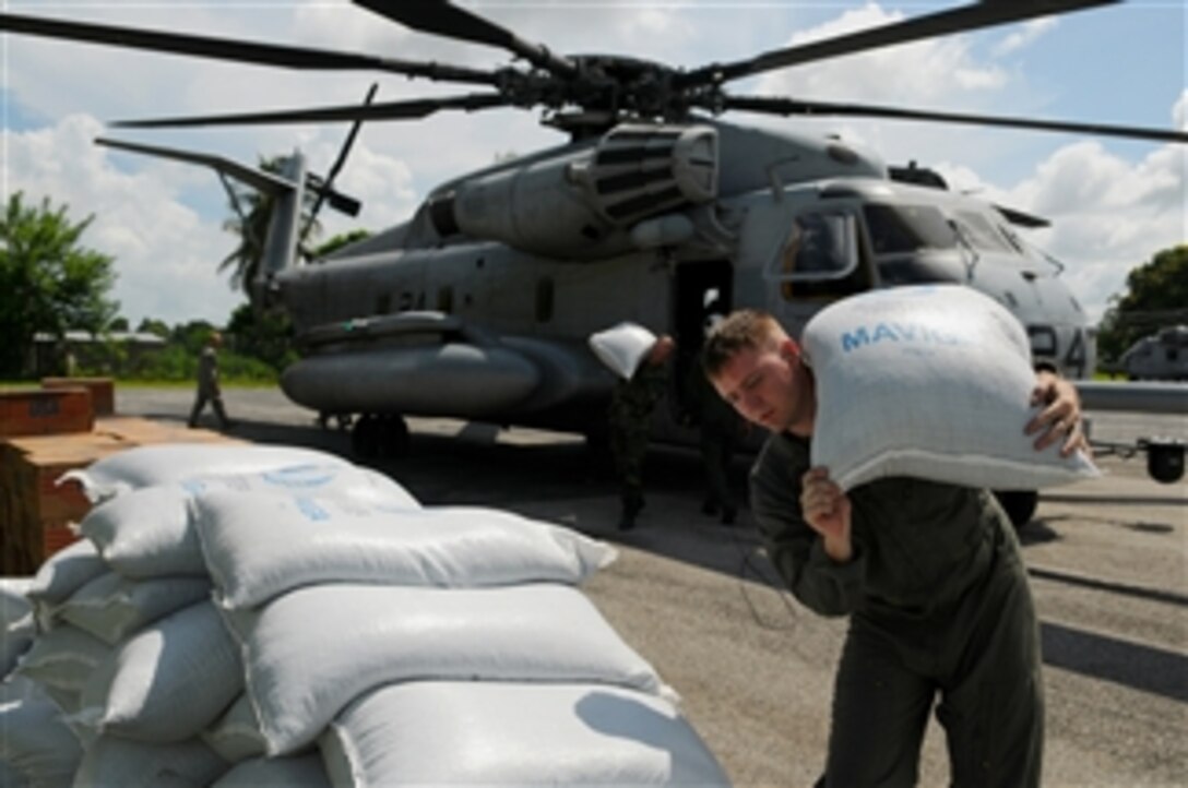 Aircrew members assigned to Marine Heavy Helicopter Squadron 464, embarked aboard the amphibious assault ship USS Kearsarge (LHD 3) unload humanitarian supplies in Port-au-Prince, Haiti, on Sept. 13, 2008.  The Kearsarge was diverted from its scheduled deployment in support of the humanitarian assistance mission Continuing Promise 2008 to conduct hurricane relief operations in Haiti.  