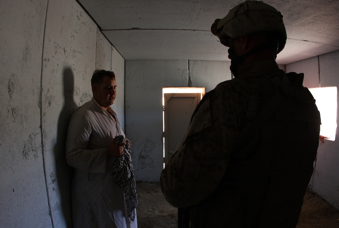 Lance Cpl. Matt Koopman, role playing a Taliban combatant, with Tactical Training Exercise Control Group, gets interrogated by a Marine with Company L, 3rd Battalion, 8th Marine Regiment, after being captured during the raiding of a mock Taliban stronghold as part of an Afghanistan-centered Mojave Viper at the Combat Center Sept. 17.