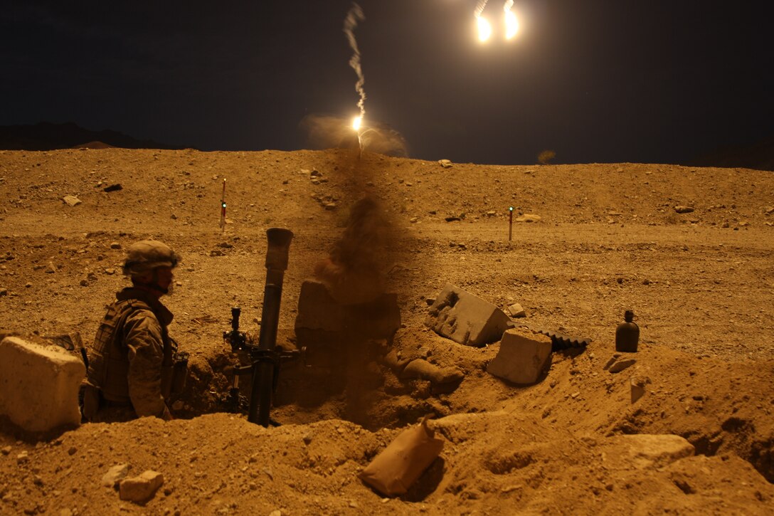 Mortar Marines with Company L, 3rd Battalion, 8th Marine Regiment, perform fire missions during a mock Taliban ambush prior to the company calling in rotary and fixed wing air strikes during an Afghanistan-centered Mojave Viper at the Combat Center Sept. 17.