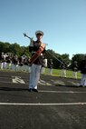 Gunnery Sgt. Sean Schmidlen, drum major for the MCAGCC 29 Palms Band, demonstrates how he uses the uses signals vice verbal commands to maneuver the band where he wants them to go during a perform for the students of Southwest High School in Green Bay, Wis., Sept. 17.  The band conducted nearly 20 performances at 13 venues throughout the state during their week long tour.