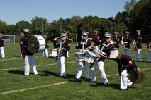 The drum line from the MCAGCC 29 Palms Band pose, following an intense demonstration of their skills, for students of Southwest High School in Green Bay, Wis., Sept. 17.  The band conducted nearly 20 performances at 13 venues throughout the state during their week long tour.
