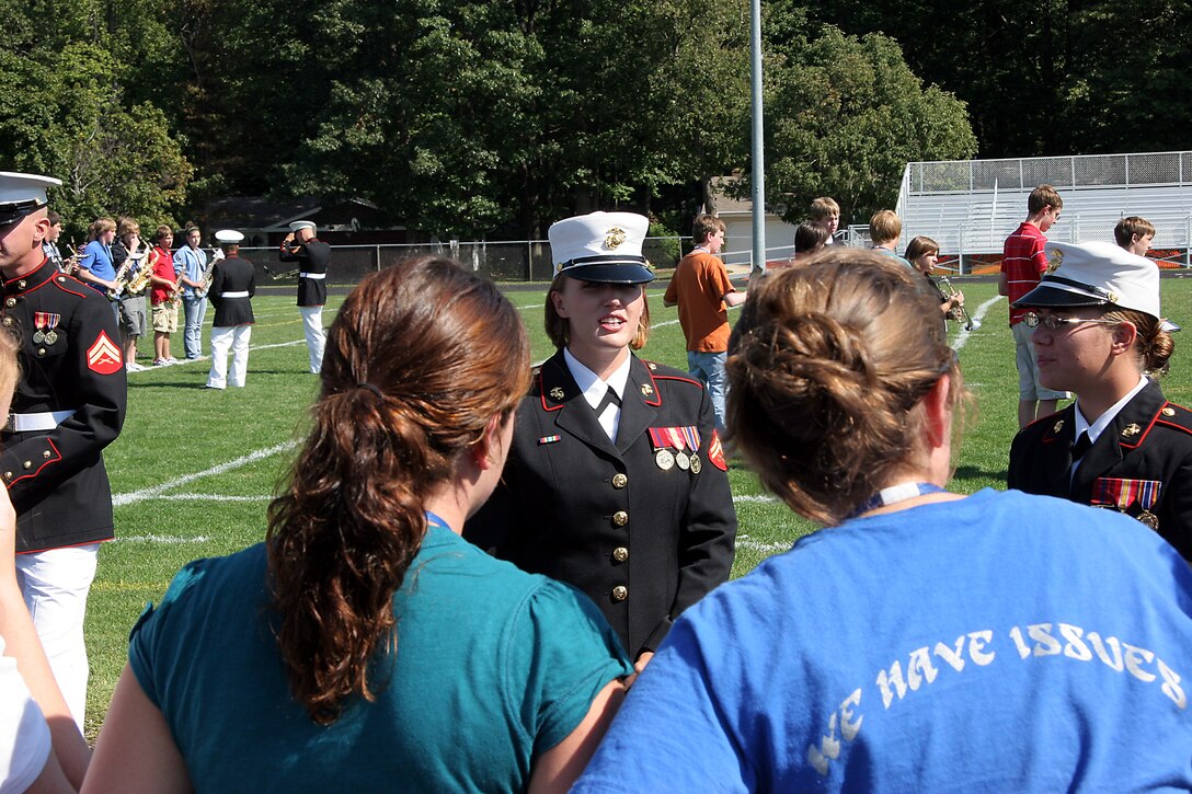 Corporal Brittany Kallash, a flute player in the MCAGCC 29 Palms Band, speaks with band students at Southwest High School in Green Bay, Wis., Sept. 17, during the clinic portion of the band's visit to the school.  During this time the school band split up by section and was given advice by Marines who play in that same section professionally in the Marine Corps.