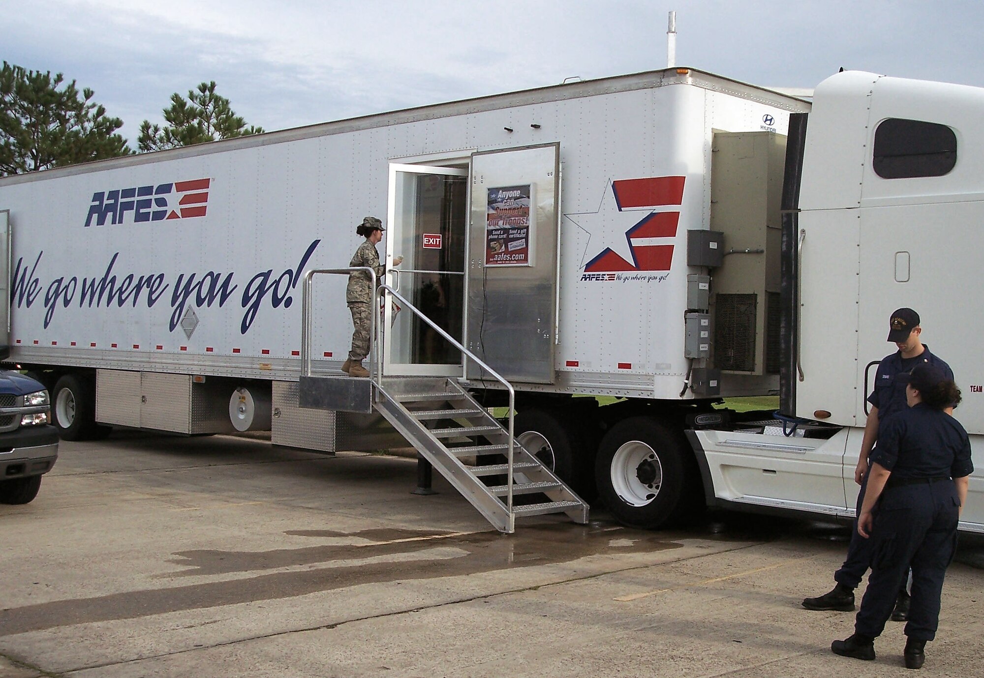 An Airman exits after shopping at the Army & Air Force Exchange Service Mobile Field Exchange at Ellington Field, Texas, Sept. 15. AAFES is providing support to service members who are providing assistance to the Houston area in the wake of Hurricane Ike. The MFE provides snacks, drinks, toiletries and ice to authorized customers and will stay at Ellington Field until the installation?s power comes back online. (Courtesy photo)