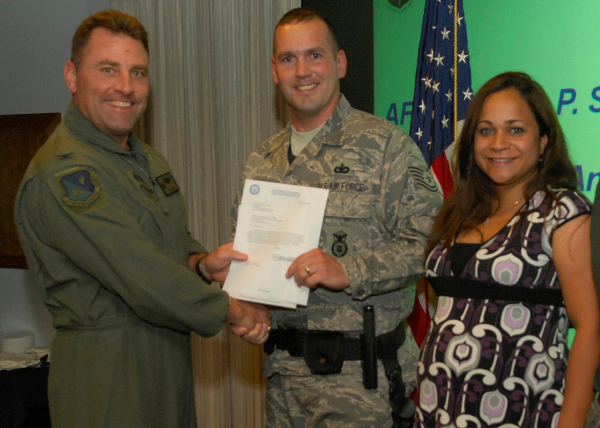 CANNON AIR FORCE BASE, N.M. - Tech. Sgt. Anthony Horde, 27th Special Operations Security Forces Squadron, his wife Gissell at his side, receives the Lance P. Sijan Leadership award from Col. Timothy Leahy, 27th Special Operations Wing commander. The award is given to an individual who demonstrates leadership through their job as well as their lives. (U.S. Air Force photo/Senior Airman Erik Cardenas)
