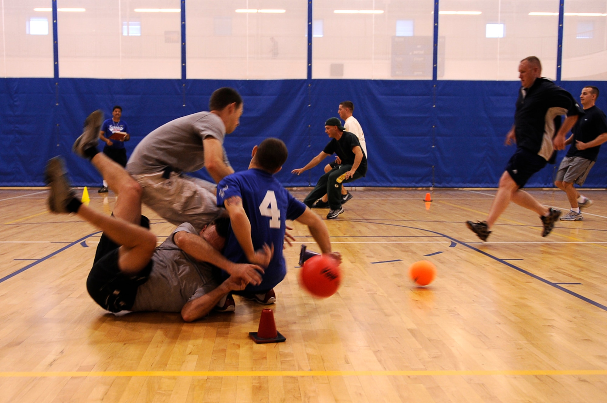 BUCKLEY AIR FORCE BASE, Colo. -- Members from the 460th Medical Group make a mad dash for the balls as they took on the 460th Security Forces Squadron in dodge ball during the Team Buckley Sports and Field Day, Sept. 12, at the base Fitness Center. Events were originally scheduled to take place outside, but inclement weather forced sports day inside. Dodge ball was played in place of mushball. (U.S. Air Force photo by Tech. Sgt. Jeromy Cross)