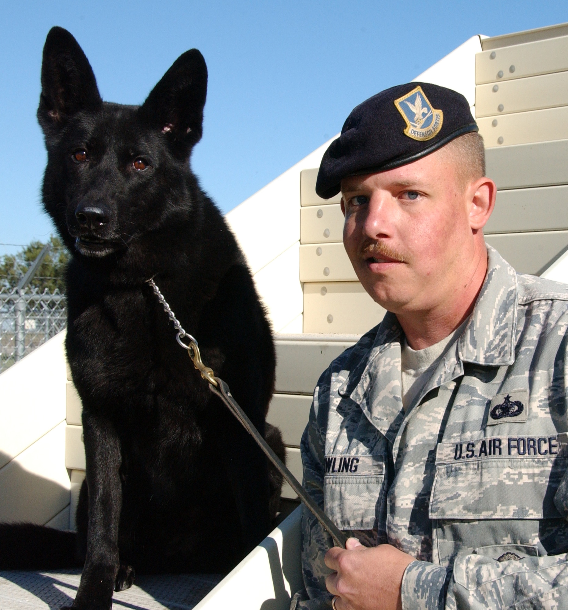 Staff Sgt. Matt Bowling and his K-9 partner, Cini, worked with other explosive-detection dog teams to clear a building in Oklahoma City prior to President George Bush’s visit last week. Sergeant Bowling and Cini are assigned to the 71st Security Force Squadron here. (U.S. Air Force photo by Joe B. Wiles)