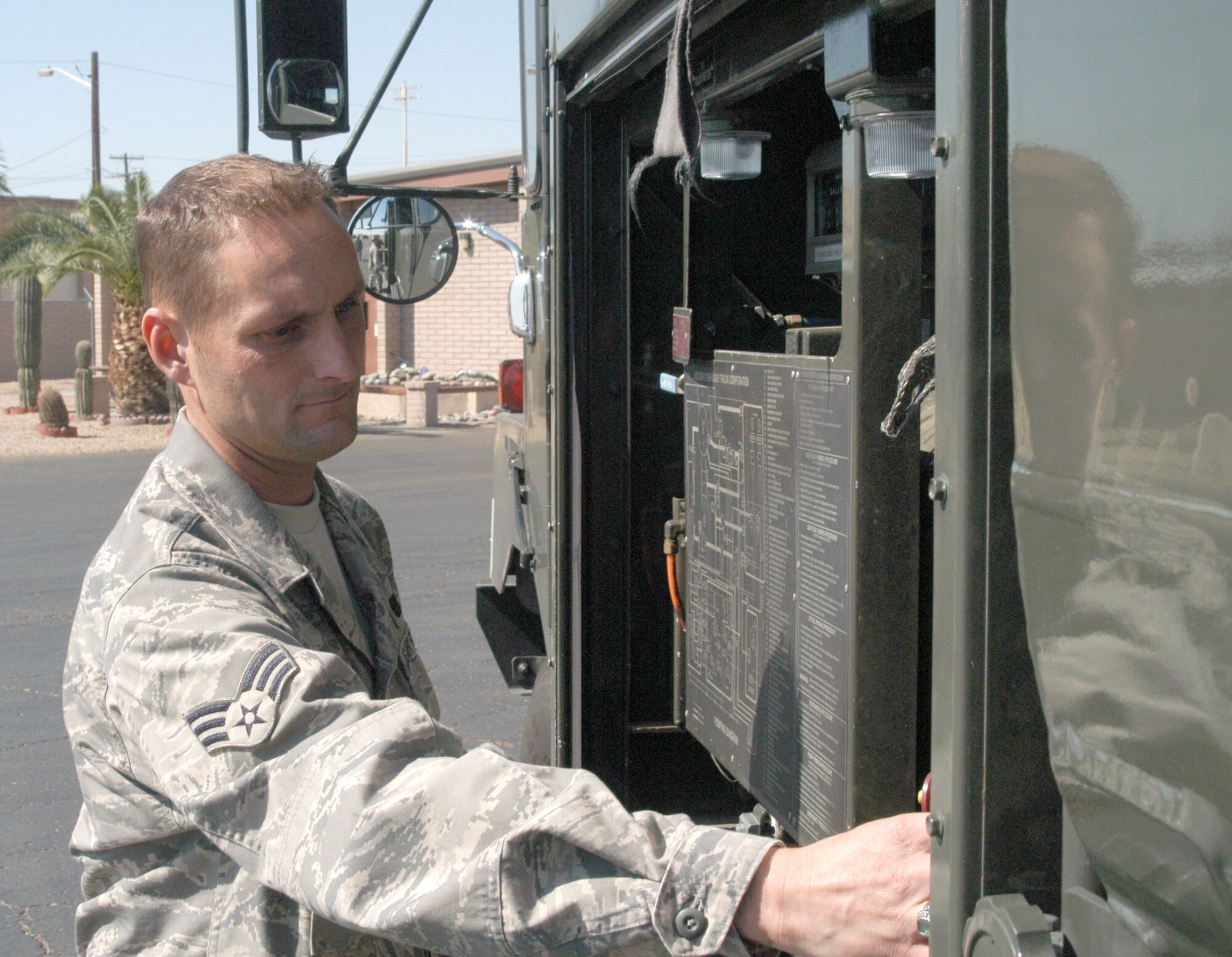 Senior Airman Matthew Fink, 944th Logisitics Readiness Squadron fuels technician, performs checks on a fuel truck. Airman Fink said he serves in the military because of patriotism. (U.S. Air Force photo/Staff Sgt. Louis Vega)