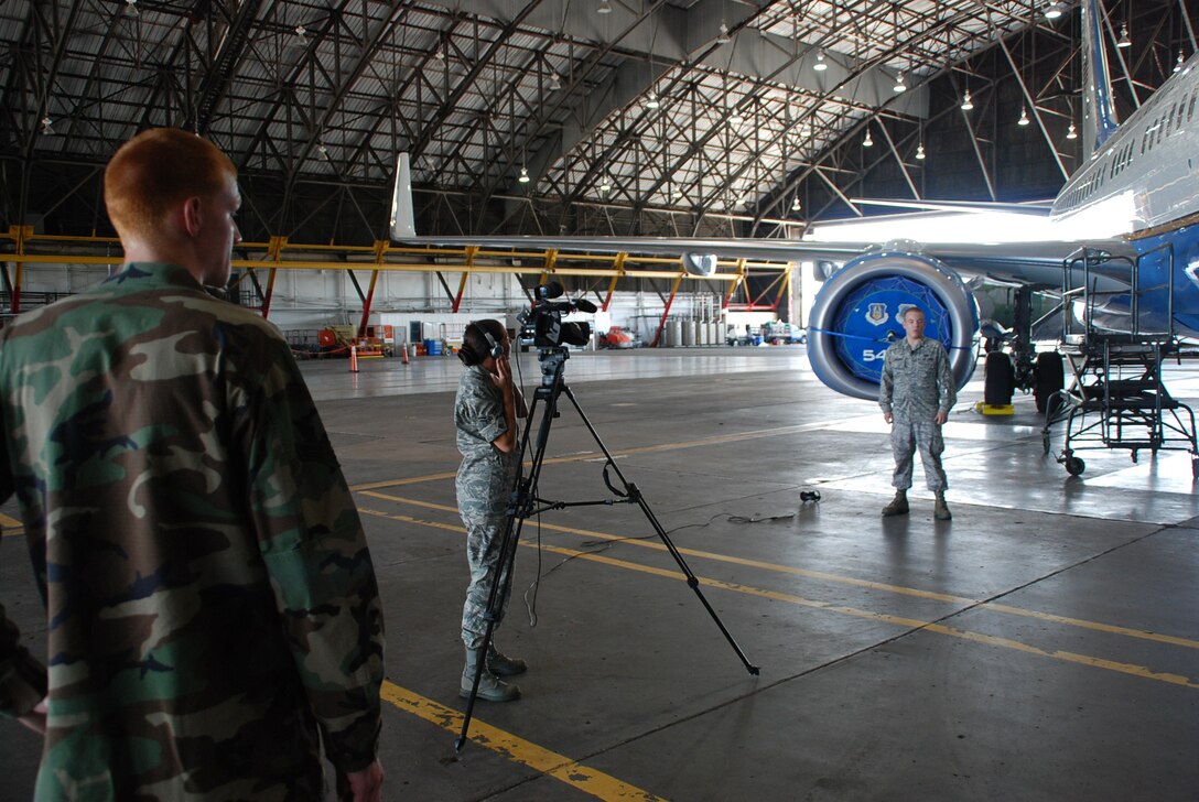 Airman First Class Jacob Schnauber, from the 932nd Airlift Wing Maintenance Group, is interviewed by the public affairs office during a documentary paying tribute to the work of the maintainers at the Air Force Reserve wing. Standing behind the camera is fellow Airman First Class Steve Kempker.  (U.S. photo by Maj. Stan Paregien)