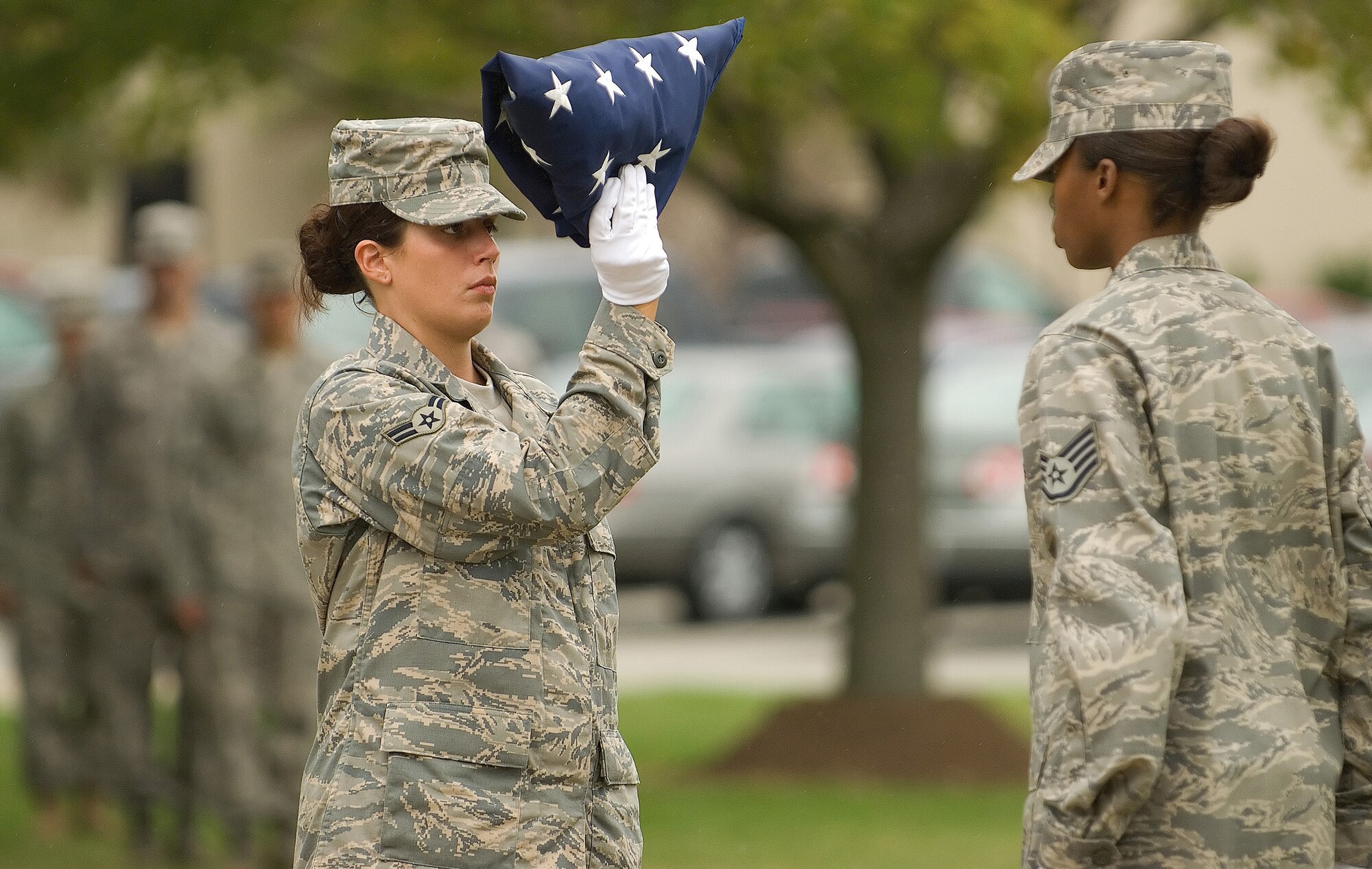 DOVER AIR FORCE BASE, Del. – Airman 1st Class Nichole Dudley, 436th Airlift Wing Honor Guard, dresses the flag before handing it to Staff Sgt. Lennell DeLoatch, 436th AW Honor Guard, during a retreat ceremony Sept. 12 at the base flag pole. The ceremony concluded Dover’s annual POW/MIA Vigil where four Airmen stood a rotating watch at the base flag pole from 6:35 a.m. to 4 p.m. The Airmen faced the four cardinal directions in remembrance of servicemembers who are missing in action or were captured.  (U.S. Air Force photo/Roland Balik)