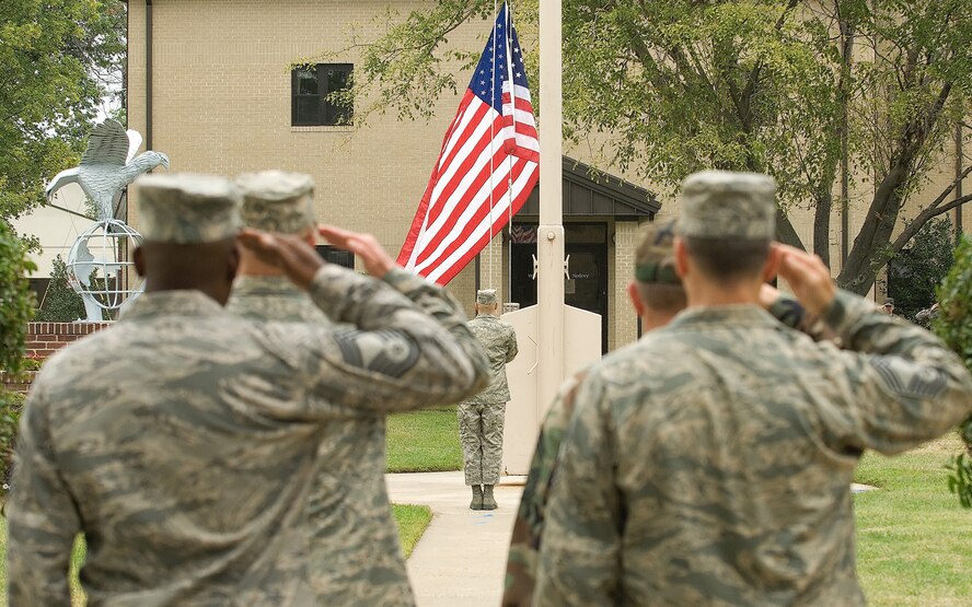 DOVER AIR FORCE BASE, Del. – Members of Dover’s Honor Guard lower Old Glory during a retreat ceremony Sept. 12 at the base flag pole. The ceremony concluded Dover’s annual POW/MIA Vigil where four Airmen stood a rotating watch at the base flag pole from 6:35 a.m. to 4 p.m. The Airmen faced the four cardinal directions in remembrance of servicemembers who are missing in action or were captured.  U.S. Air Force photo/Roland Balik)