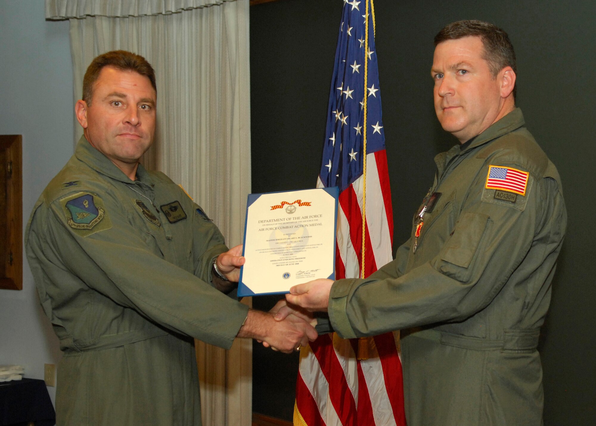 CANNON AIR FORCE BASE, N.M.- Master Sgt. Stuart Blackwood, 27th Special Operations Wing, recieves the Air Force Combat Action Medal from Col. Timothy Leahy, 27th SOW commander. Sergeant Blackwood accepted the award Sept. 16 at the weekly wing staff meeting. (U.S. Air Force photo/Senior Airman Erik Cardenas)