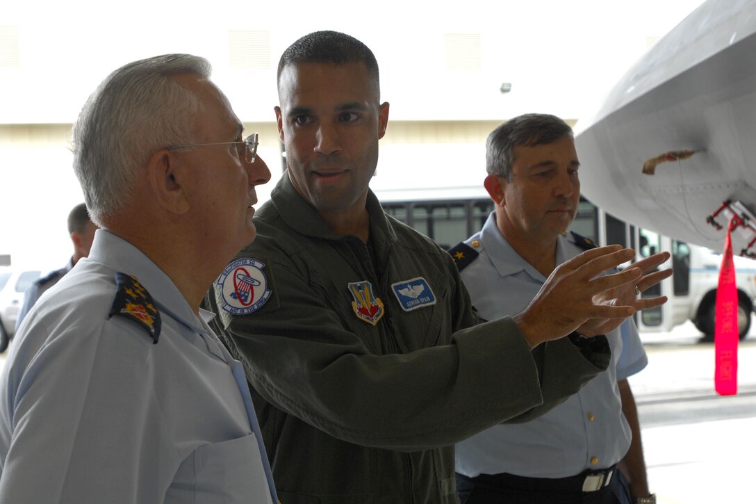 LANGLEY AIR FORCE BASE, Va. -- Maj. Adrian Spain, 94th Fighter Squadron, points out several features of the F-22 Raptor to Gen. Aydongan Babaoglu, commander of the Turkish air force, during his tour of the static display Sept 10. During his time on base, General Babaoglu met with several members of the senior leadership and was introduced to some of Langley’s operations. (U.S. Air Force photo/Airman Rebecca Montez)